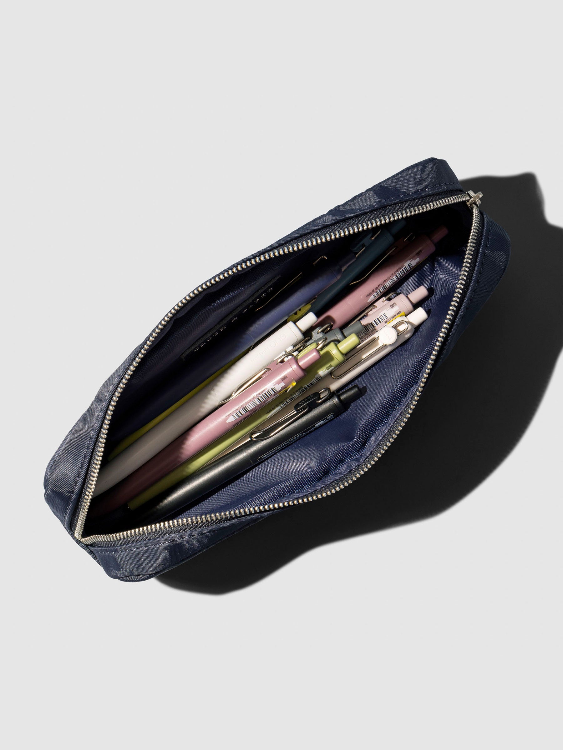 Top down view of a selection of pens stored inside the pouch. Color featured is Apollo.