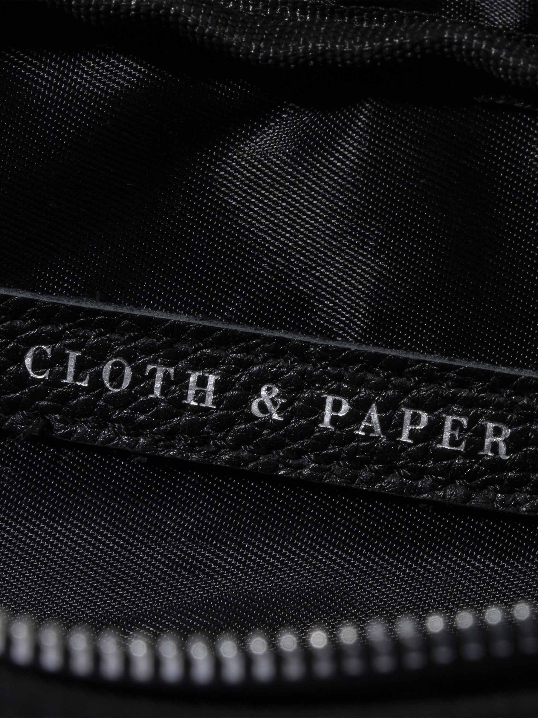 Closeup of Cloth and Paper logo inside of pencil pouch. Color featured is black.