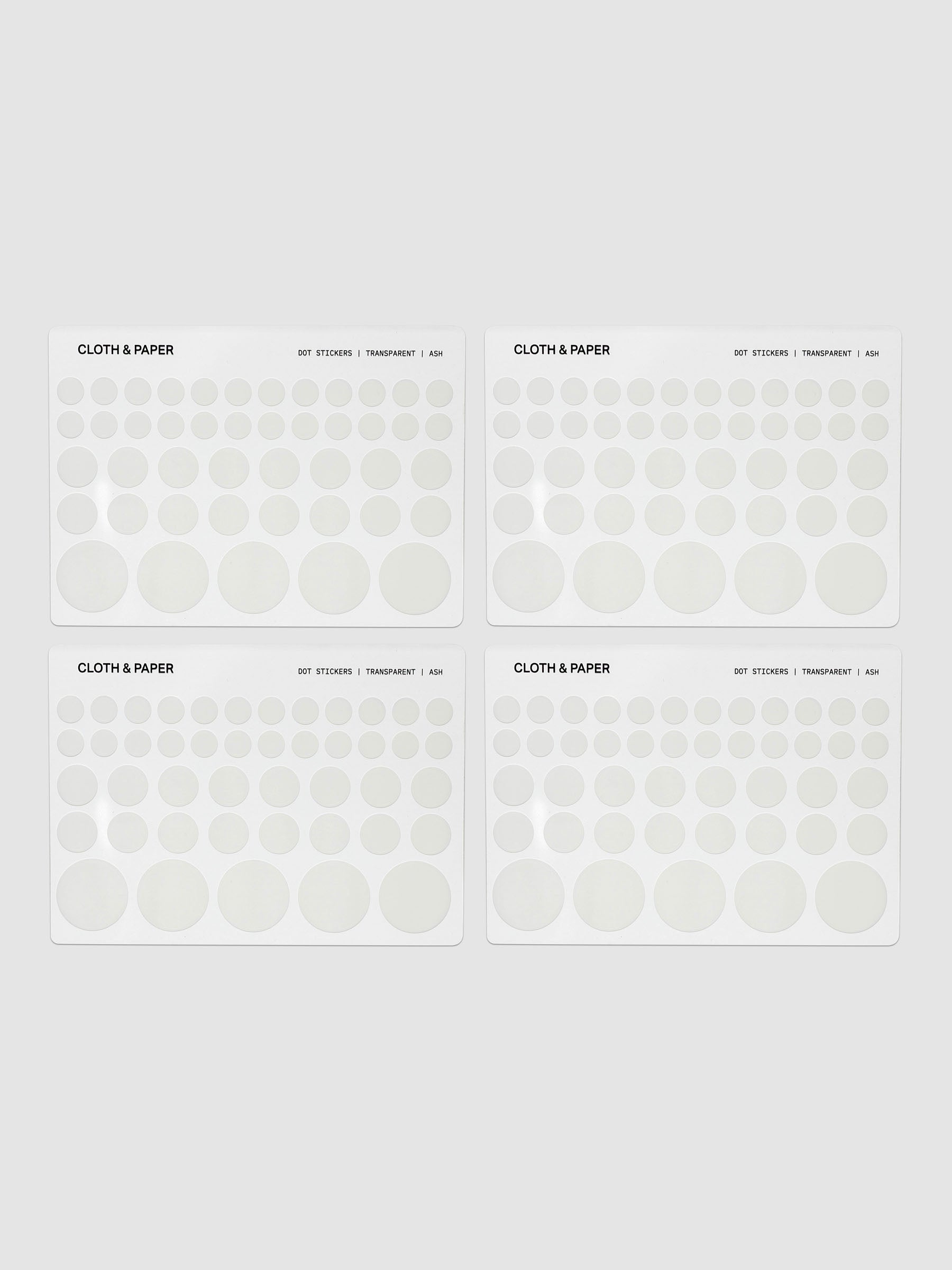 Four sheets of transparent dot stickers with letters design in small, medium, and large sizes shown against a neutral background.