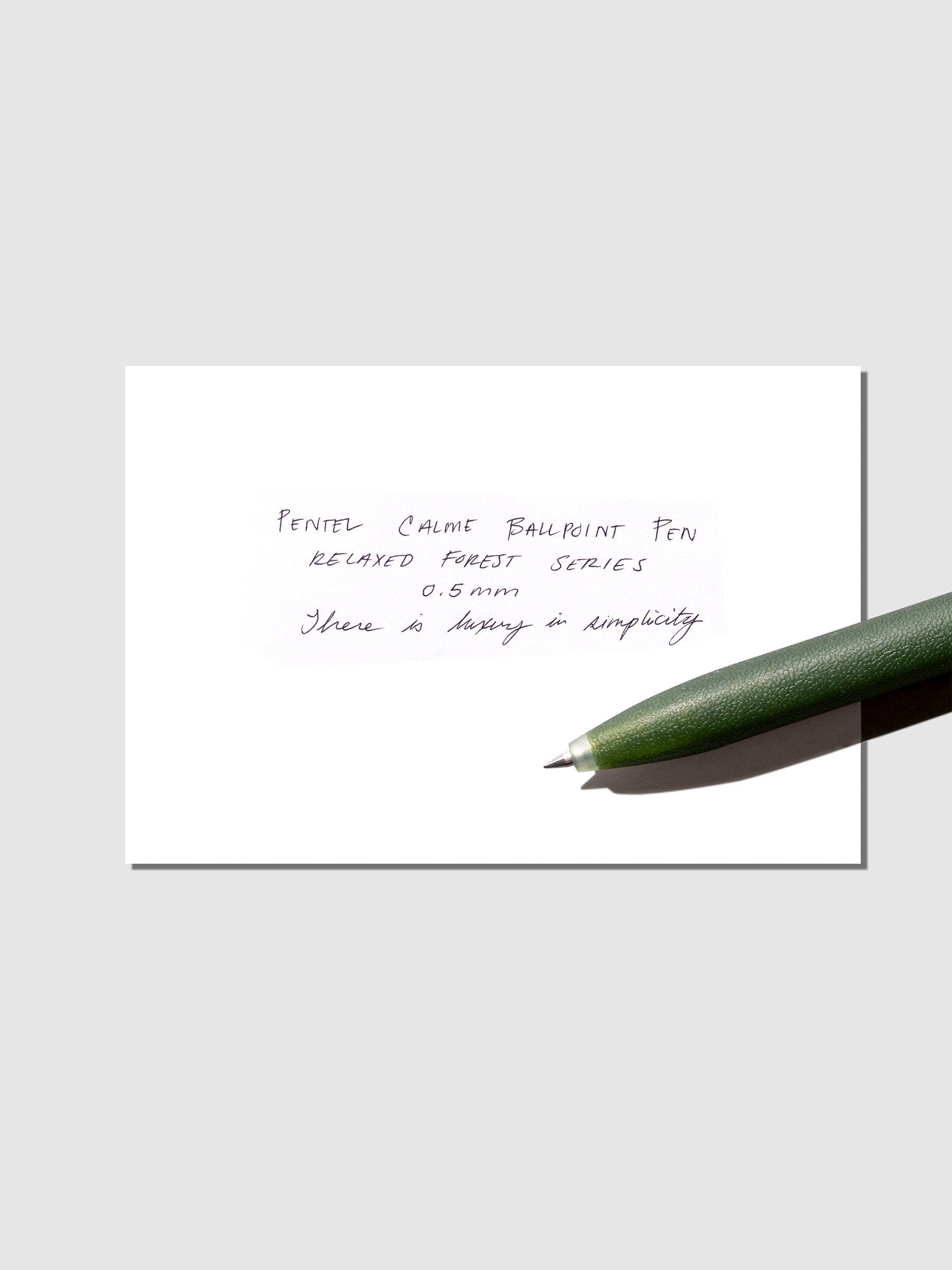 Pen test sheet shown with olive pen on a neutral background.