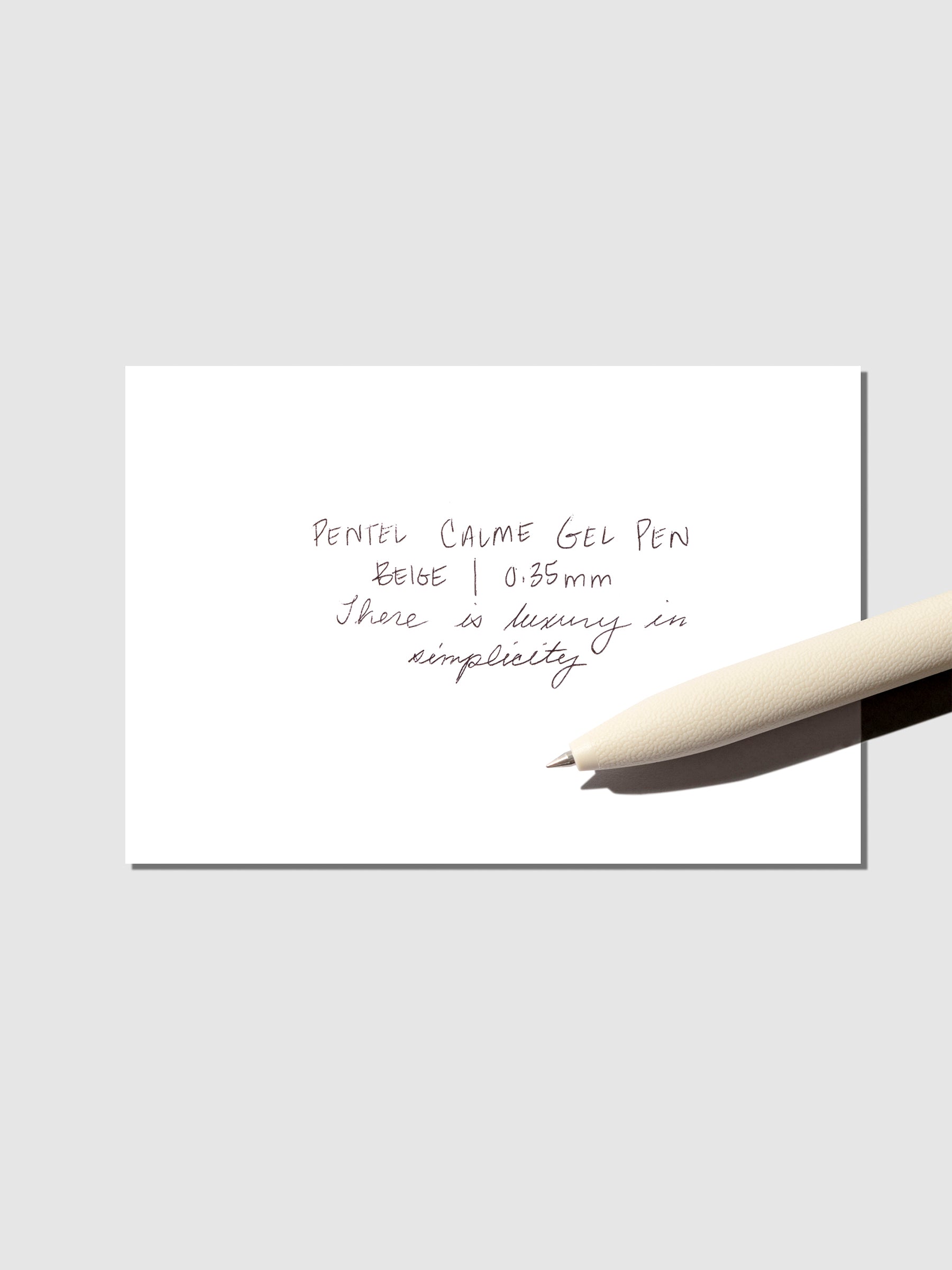 Pen displayed with a pen testing sheet on a neutral background.