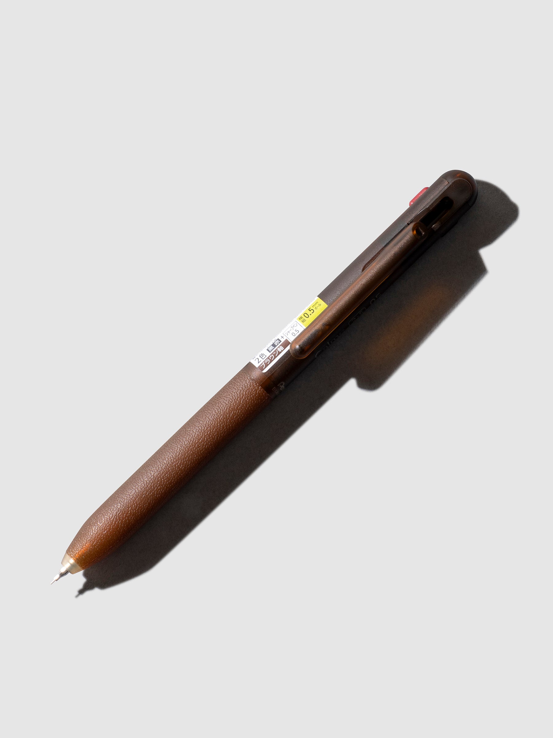 Pentel Calme Multifunction Ballpoint Pen, Cloth and Paper. Brown pen shown on a neutral background.