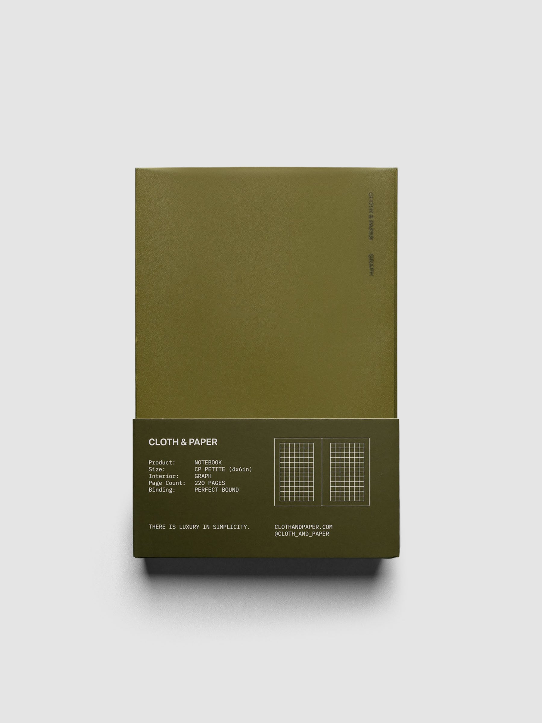 Perfect Bound Notebook | CP Petite | Graph | Olive shown closed, laying flat, in packaging, on a neutral background.