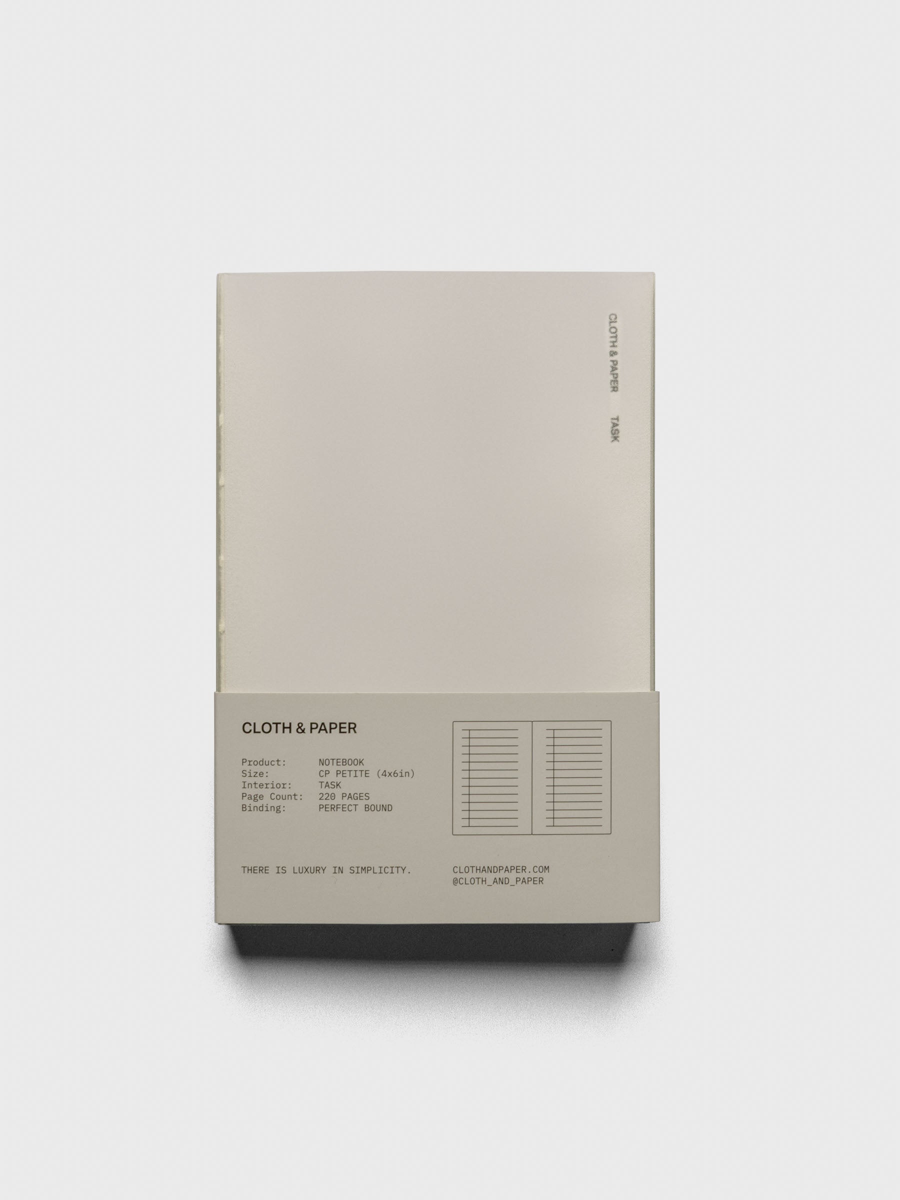 Perfect Bound Notebook | CP Petite | Task | Ristretto closed, laying flat in packaging, on a neutral background.