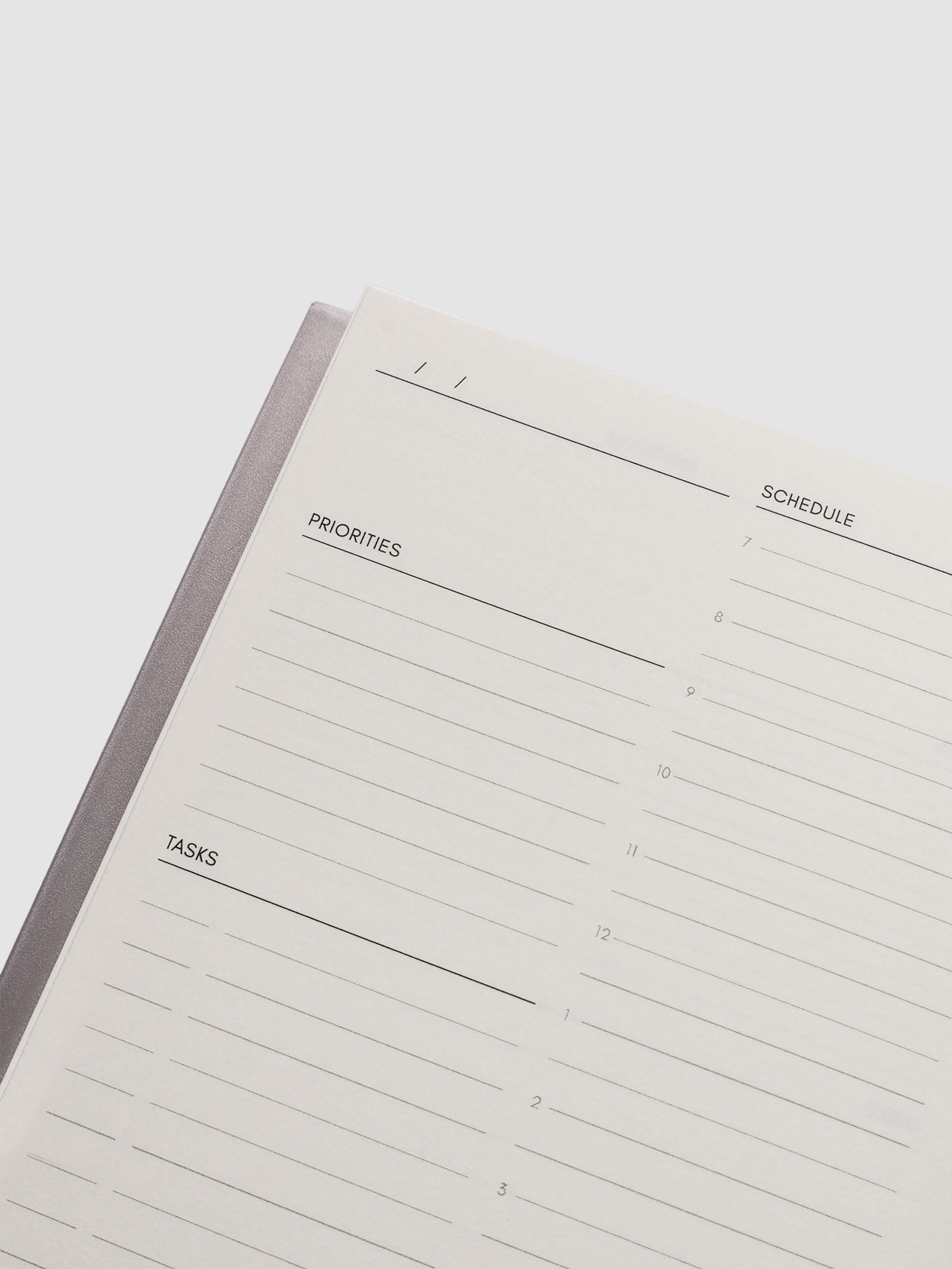 Perfect Bound Notebook | CP Petite | Undated Daily | Verona shown open, laying flat, on a neutral background. Each page has a header for date, priorities, tasks, and schedule.