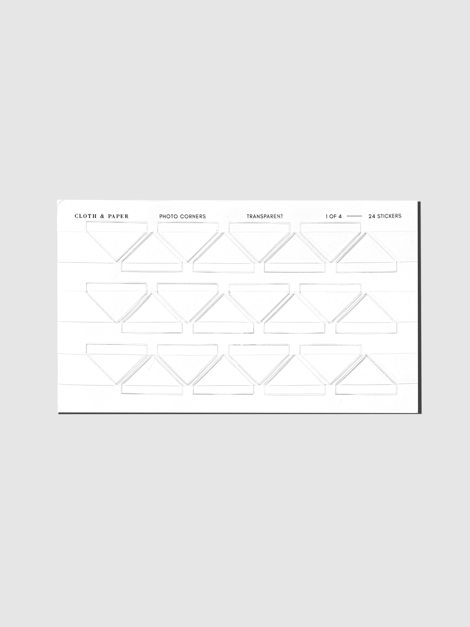 Set of clear photo corner stickers displayed on a neutral background.