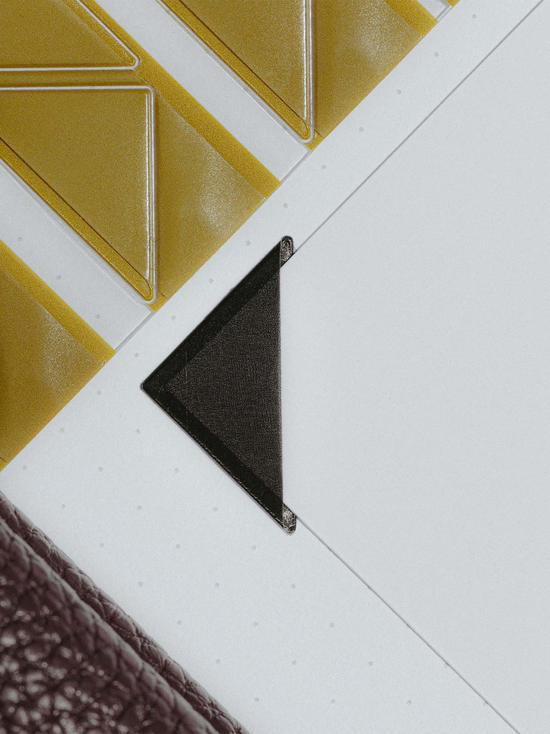 Photo corners shown in use inside a planner insert.