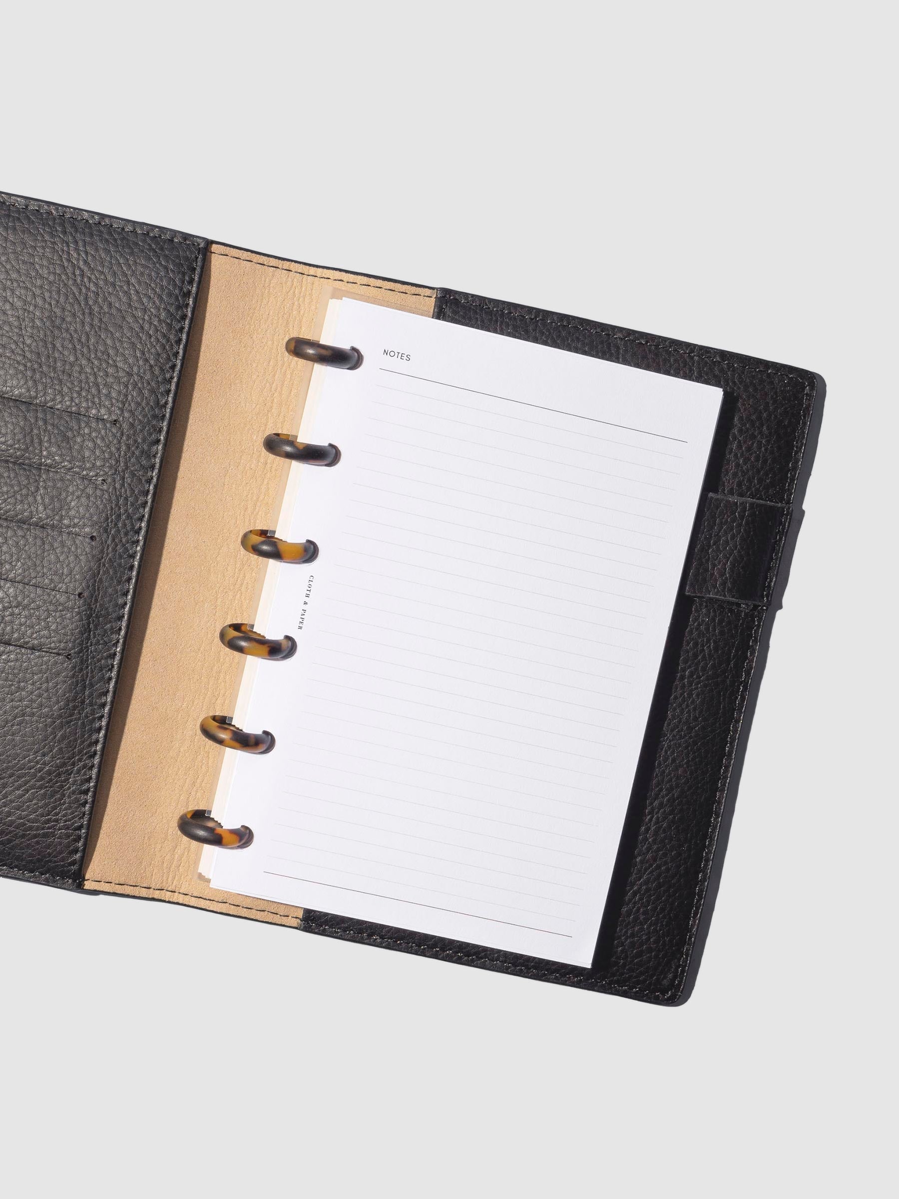 Discs in use inside a black leather agenda.