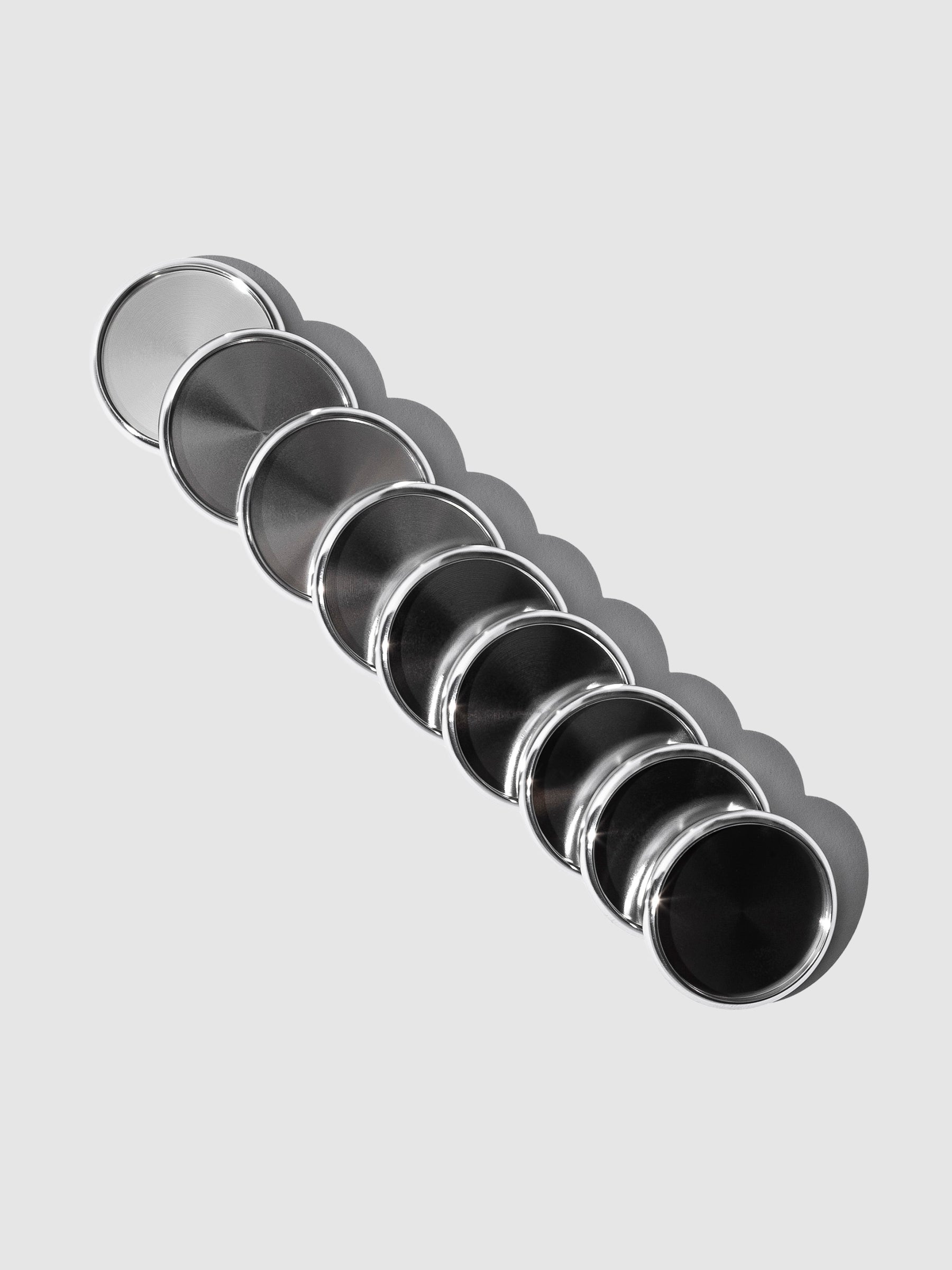 Planner Discs in Silver Aluminum with a 1.25 inch diameter stacked to the left against a neutral background.