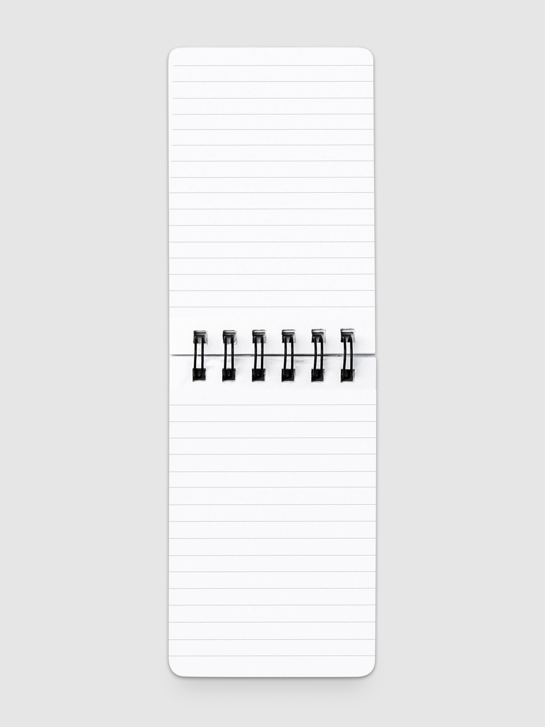 Lined notepad open on a neutral background.