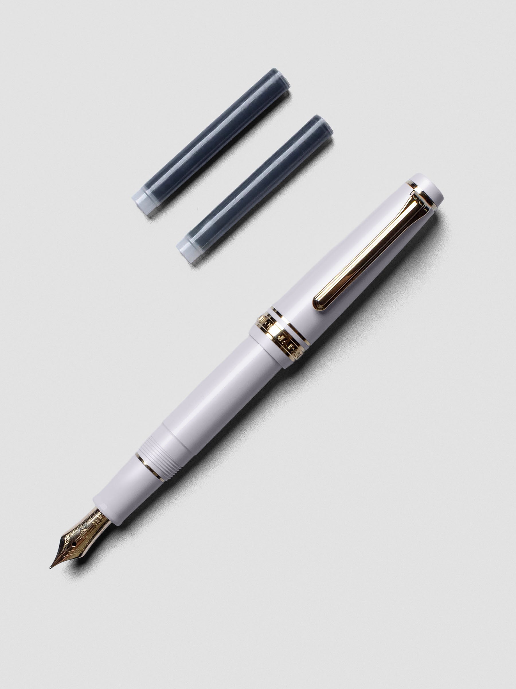 Sailor Pro Gear Slim Mini Fountain Pen in Ayur Gray with cap posted on the back.