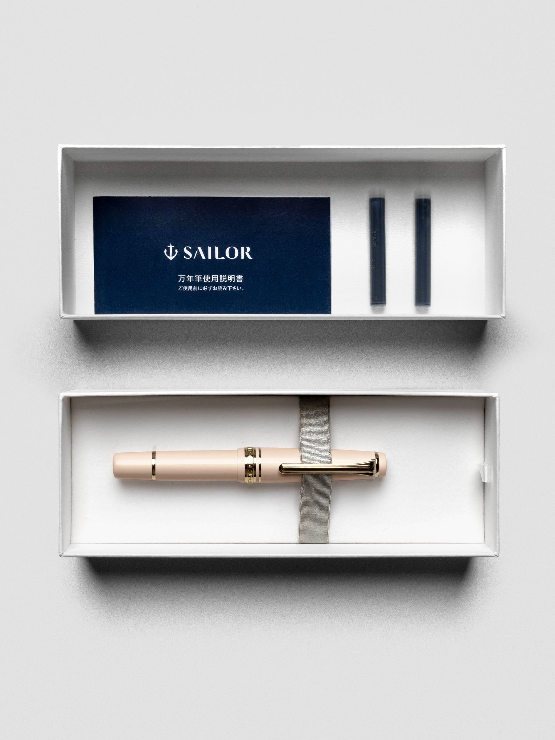 Sailor Pro Gear Slim Mini Fountain Pen in Zween Pink, shown capped against a neutral surface.