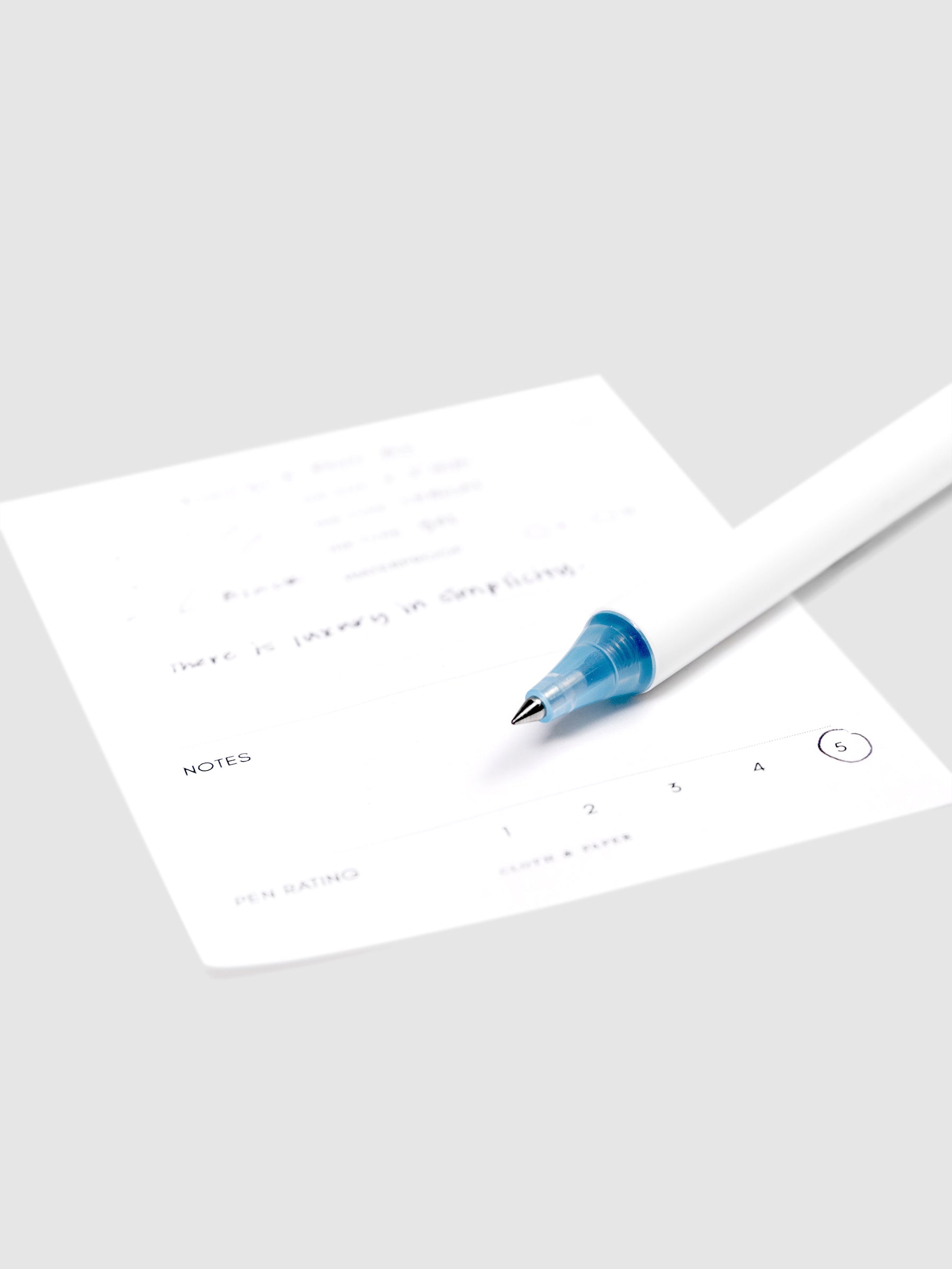 Always a Fave Pen, Light Blue, Cloth and Paper. Close up on pen nib resting on pen test sheet.