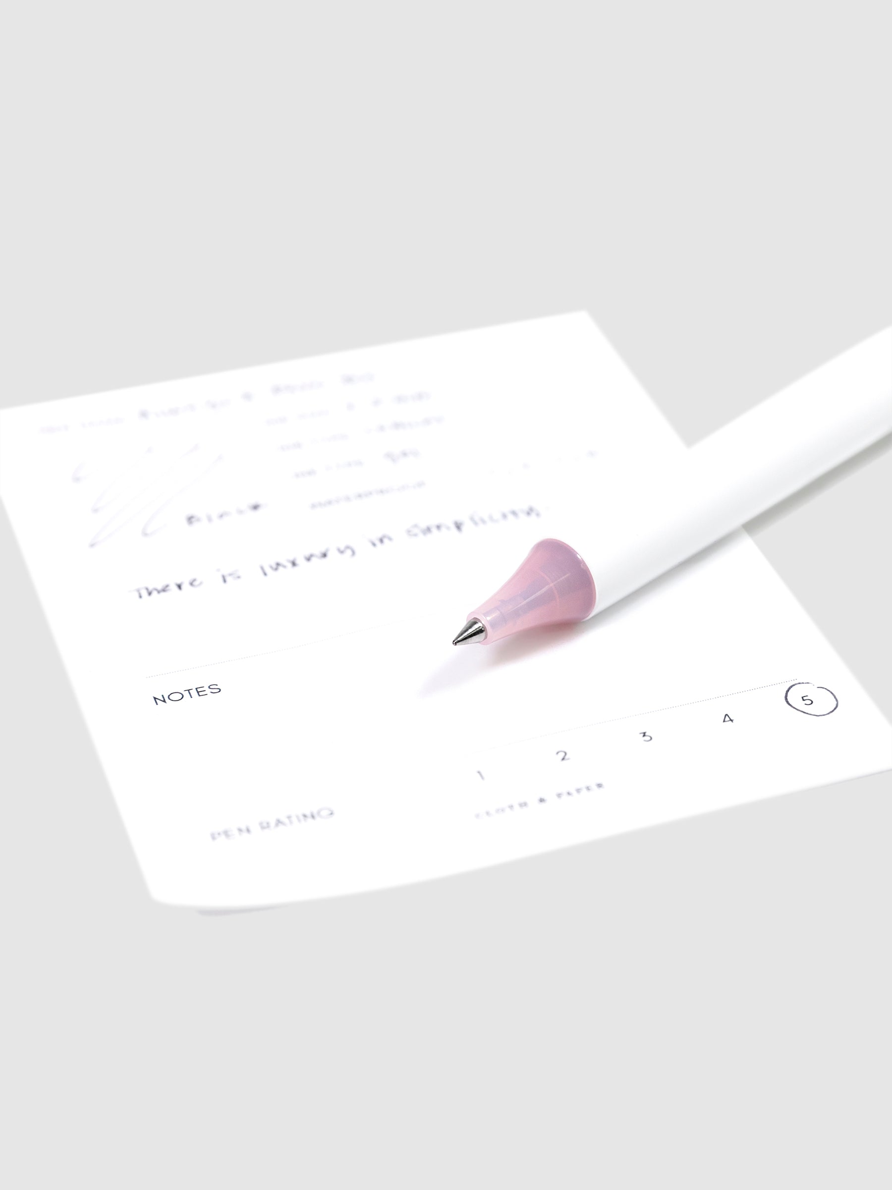 Always a Fave Pen, Pink, Cloth and Paper. Close up on pen nib resting on pen test sheet.