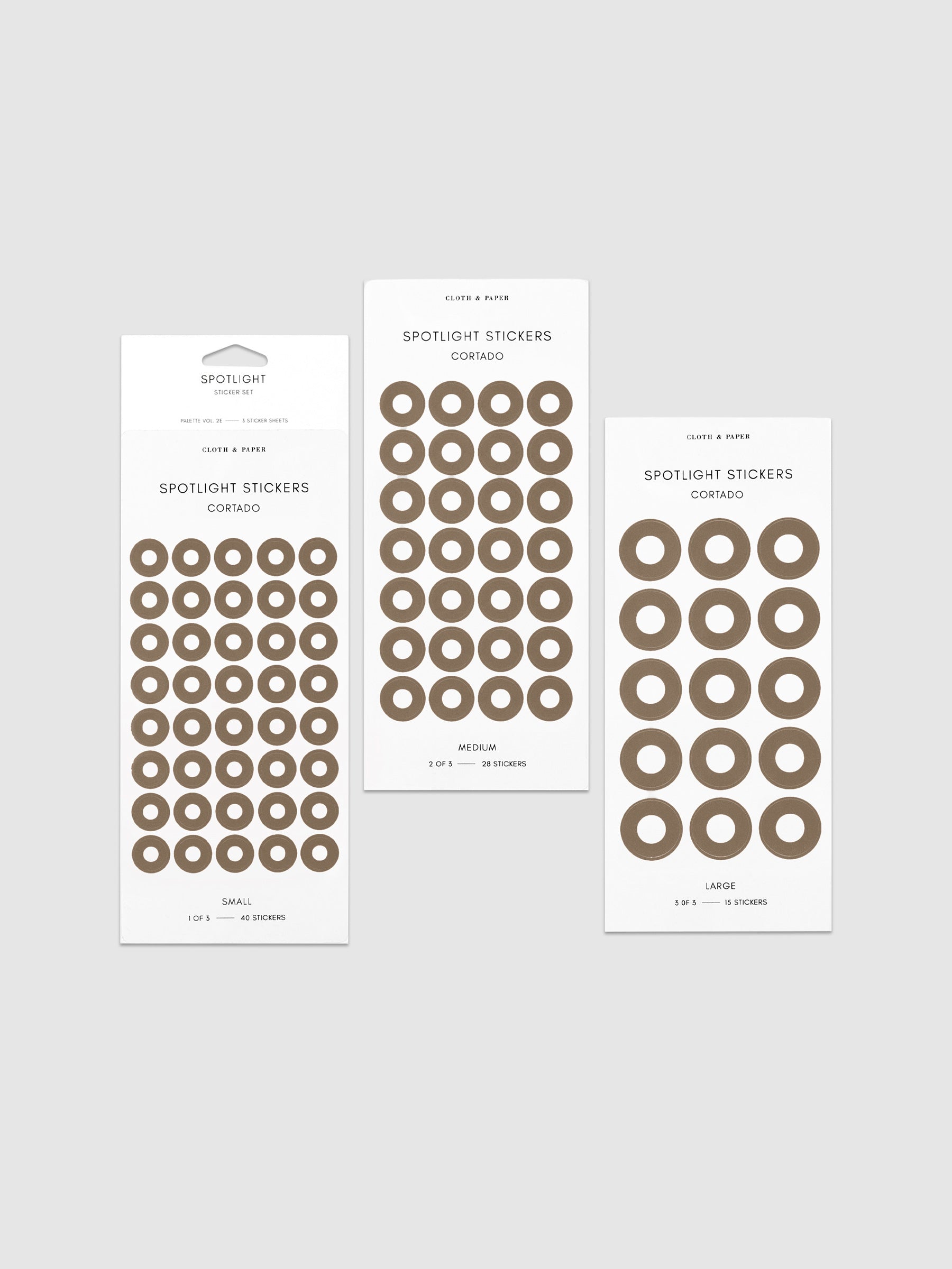 Three sheets of spotlight stickers in small, medium, and large sizing arranged together on a neutral background.