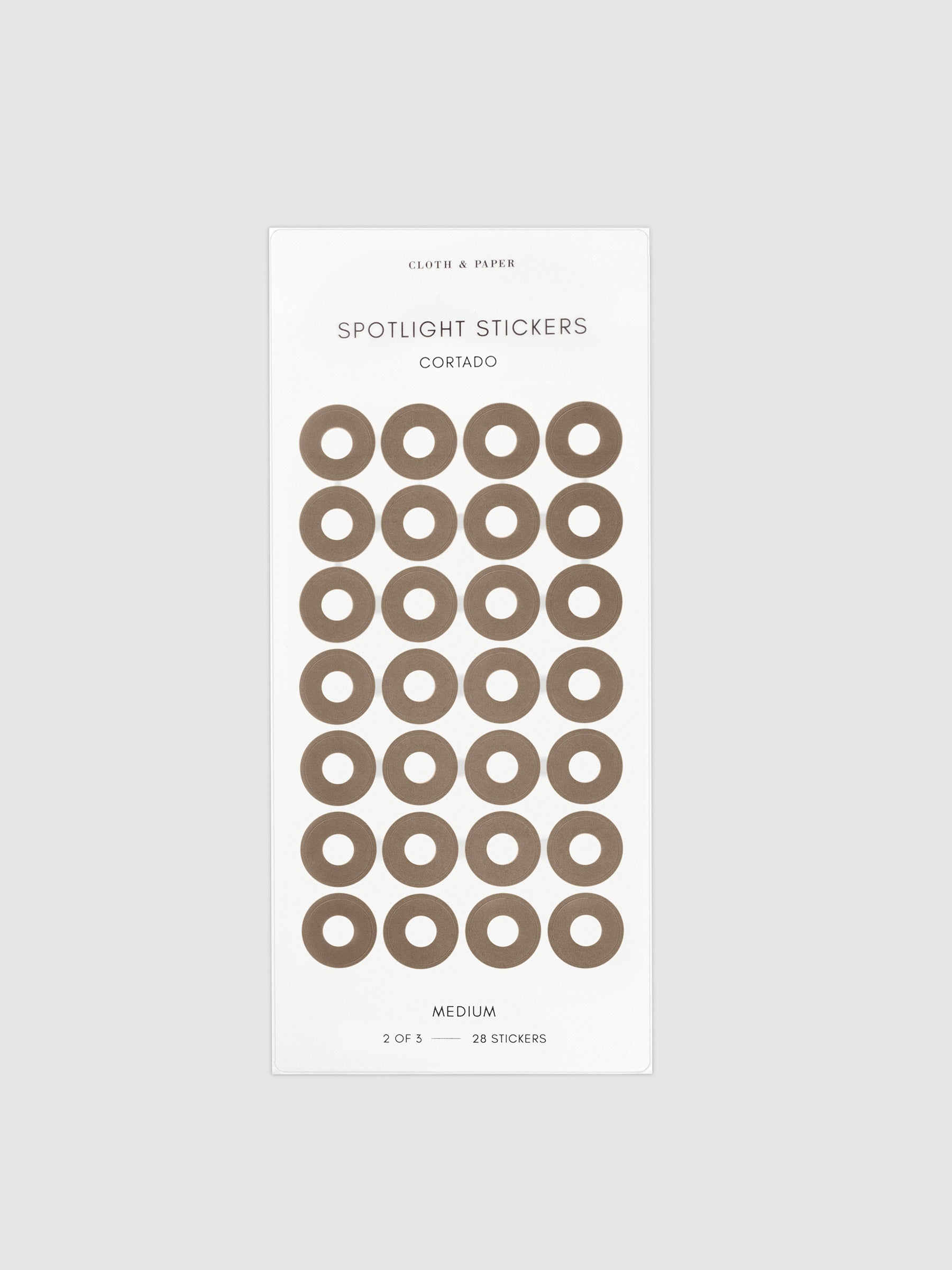 Medium sticker in its packaging displayed on a neutral background. Pictured color is cortado.