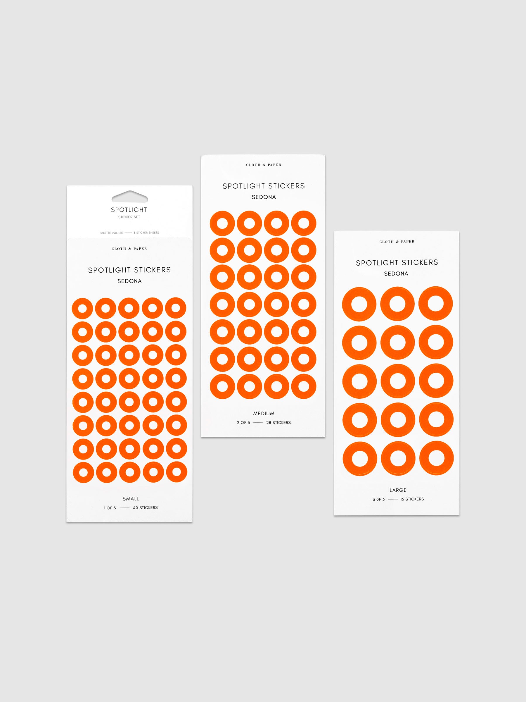 Three sheets of spotlight stickers in small, medium, and large sizing arranged together on a neutral background.