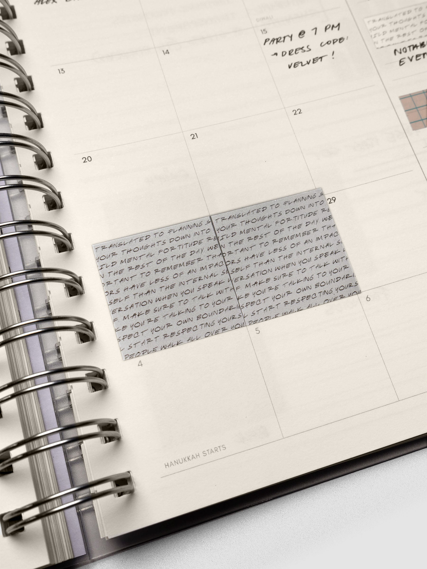 Close up of the Square Page Flags in the silver, semi-transparent footnotes pattern shown in a spiral planner.
