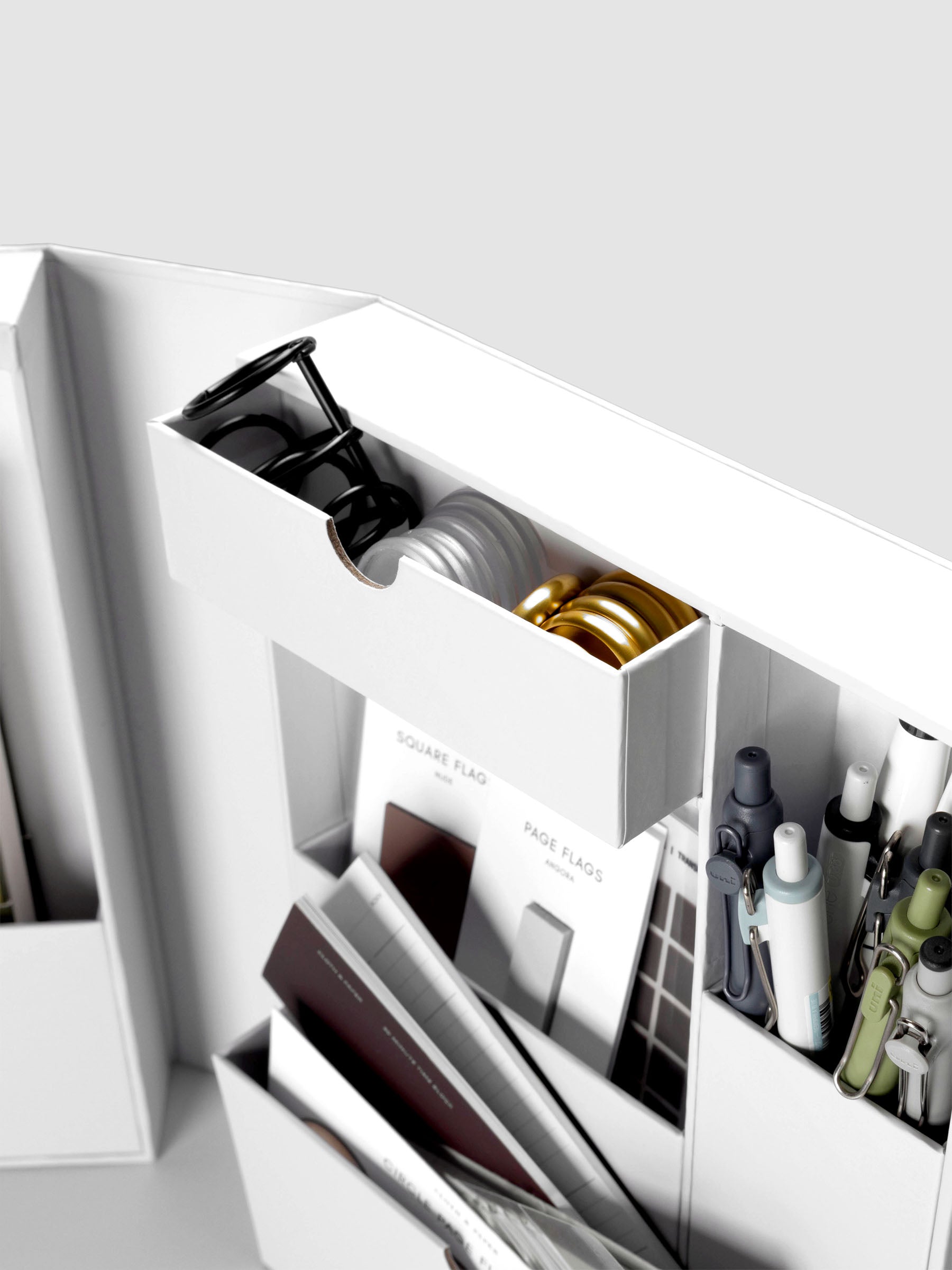 Storage Book 4.0 close up of open drawer with planner discs and planner rings inside.