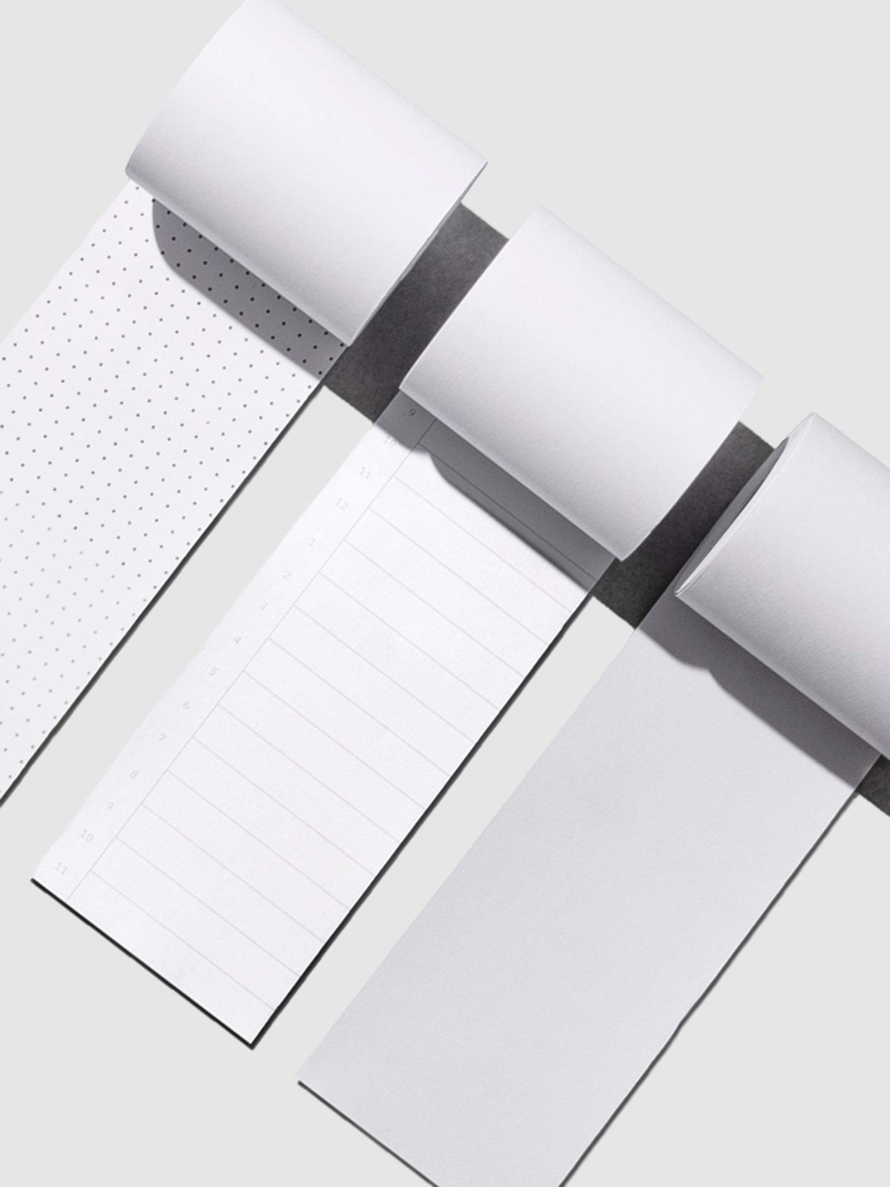 From left to right, the image shows the designs for the dot grid task roll, the time block task roll, and the blank task roll.