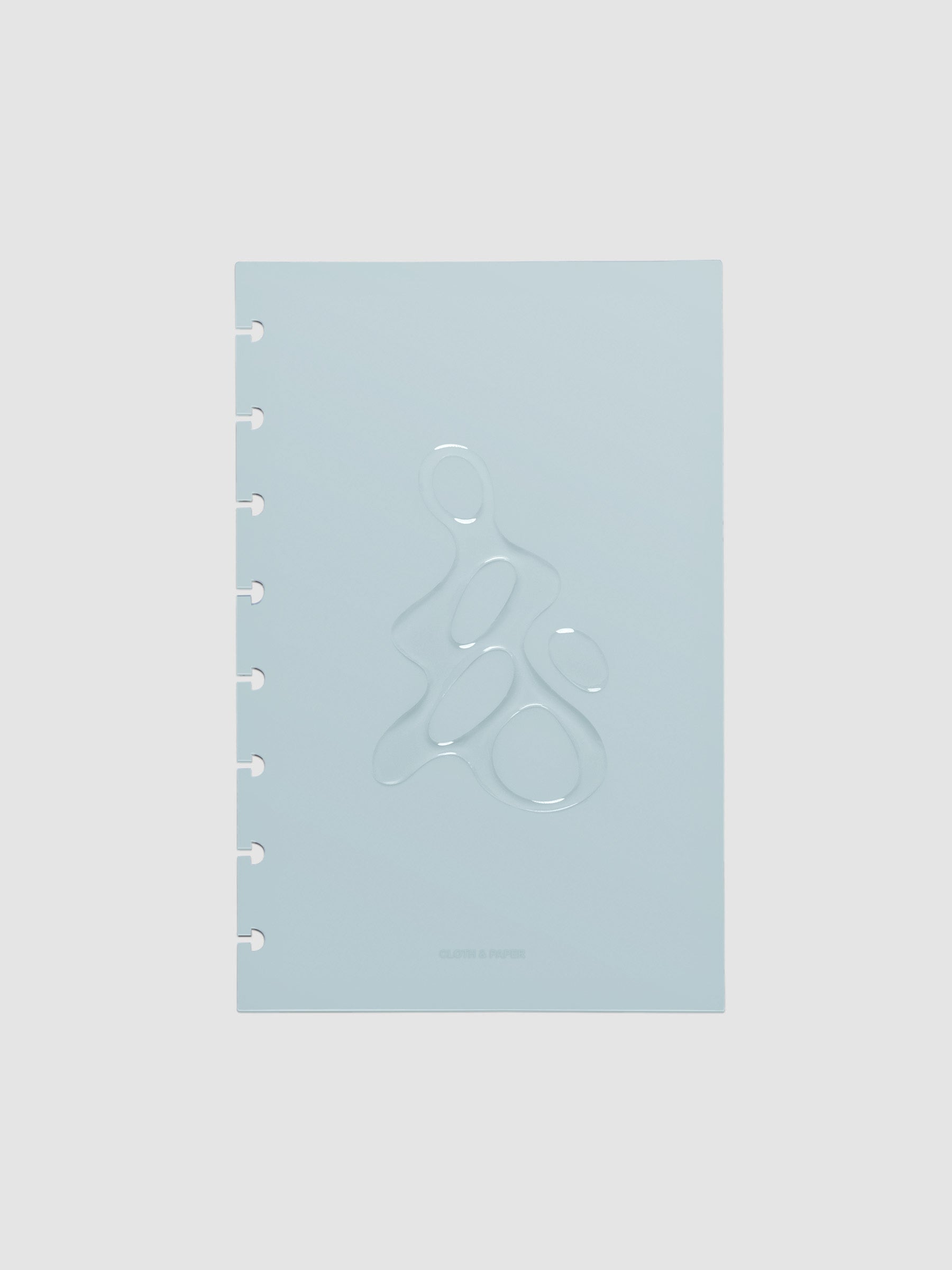 Light blue, semi-transparent, and glossy plastic planner dashboard with organic raised shape design in size Half Letter on a neutral background.