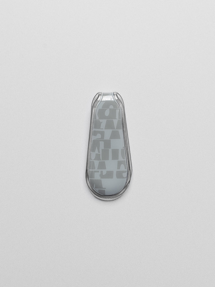 Blue patterned magnetic bookmark shown closed, laying flat on a neutral background.