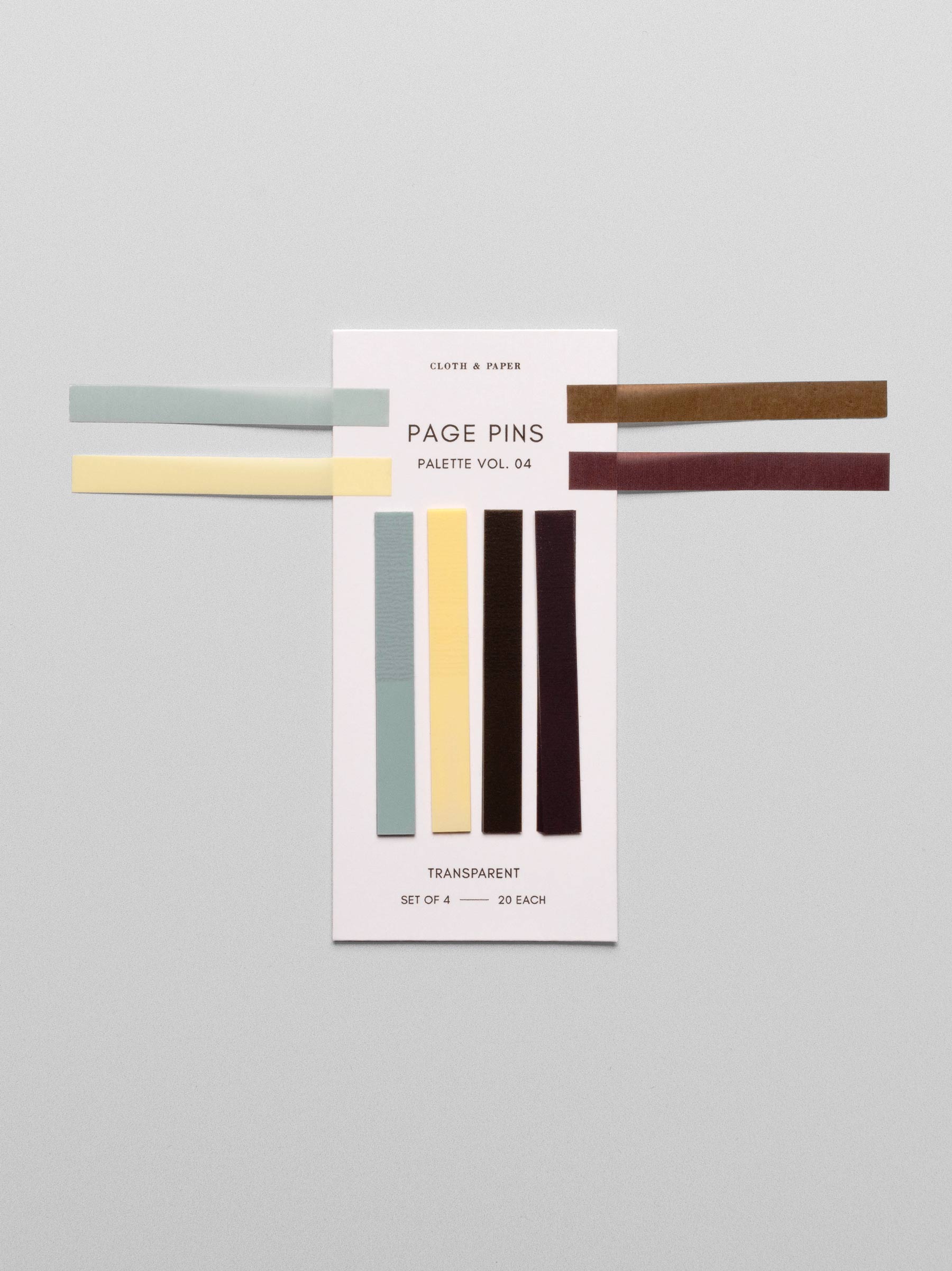 Page Pins Vol. 4 in colors Smoked Salt (blue), Mallorca (yellow), Walnut (brown), and Bordeaux (Burgundy) shown on backing card on a neutral background. One of each page pin is laid on top of the set to show true colors.