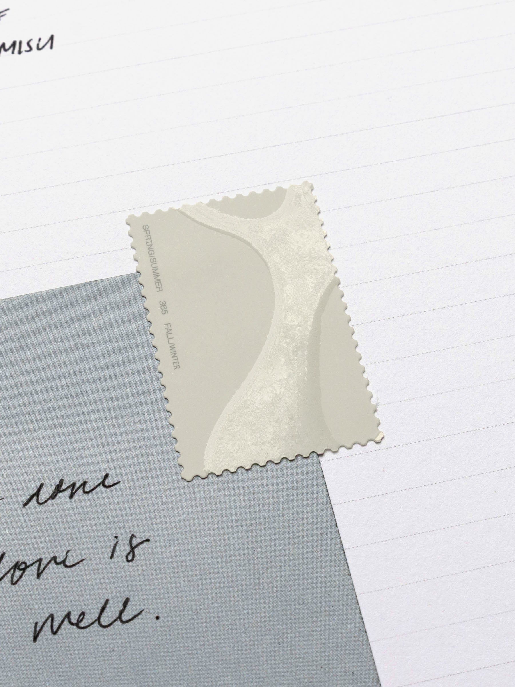 Close up image of a note affixed to a planner insert using a Stamp Sticker | Gloss Form in an off-white color.