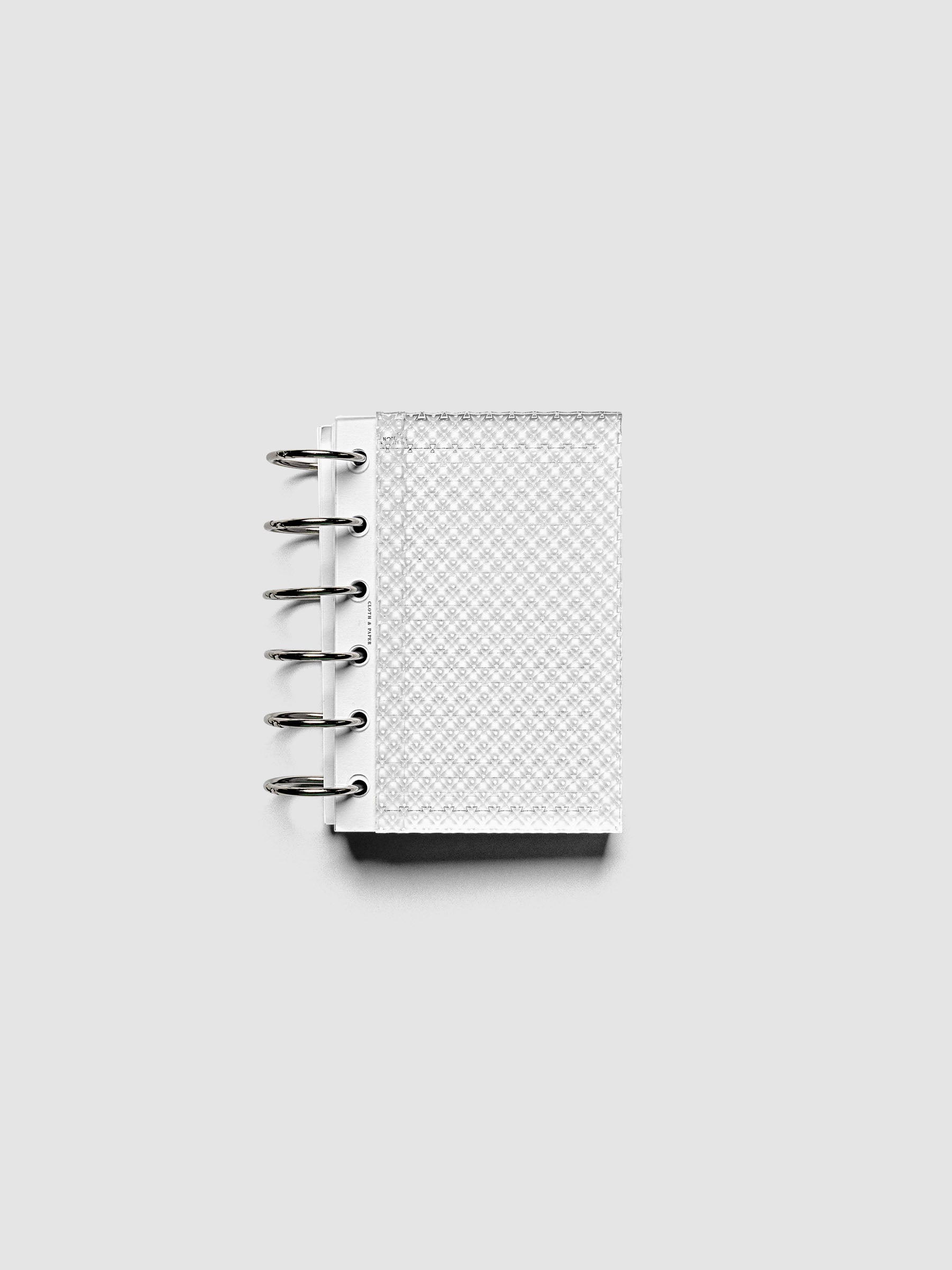 Clear, textured Studded Planner Dashboard in the size Pocket, shown ringbound.