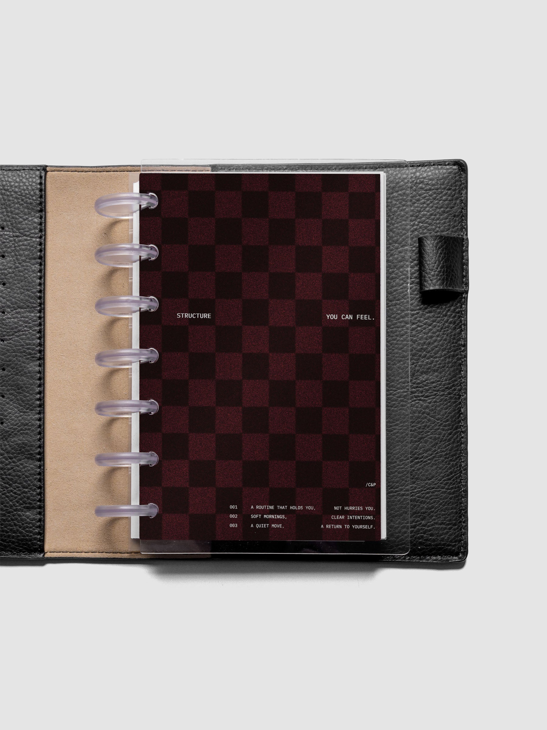 HP Mini sized velvet checkered dashboard in the color Bordeaux with crystal clear planner dashboard shown inside a black leather folio.