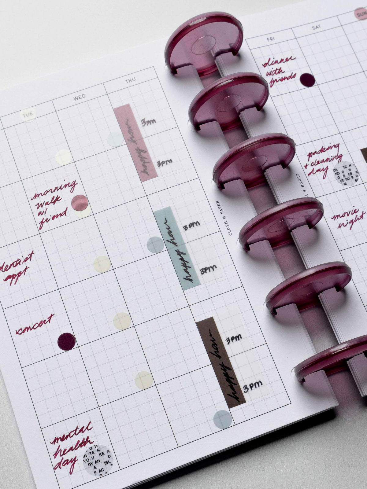 Planner with purple planner rings on a white surface