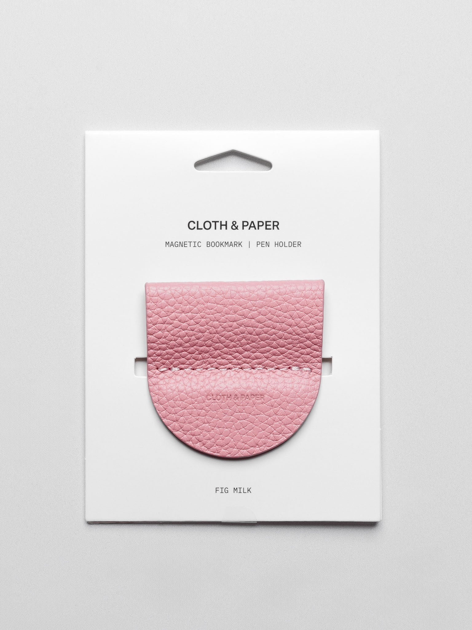 Magnetic Bookmark | Pen Holder in color Fig Milk (light pink) shown in packaging.