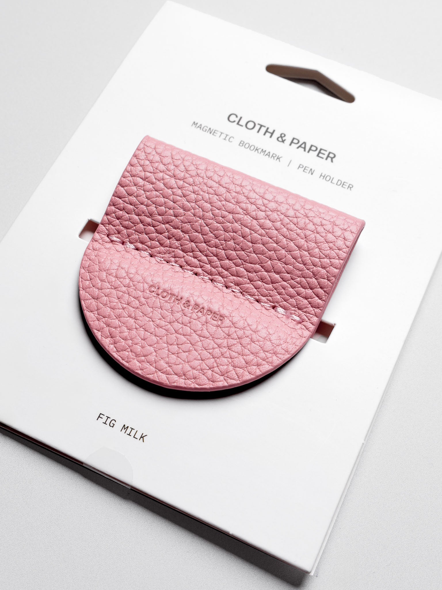 Magnetic Bookmark | Pen Holder in color Fig Milk (light pink) shown in packaging.