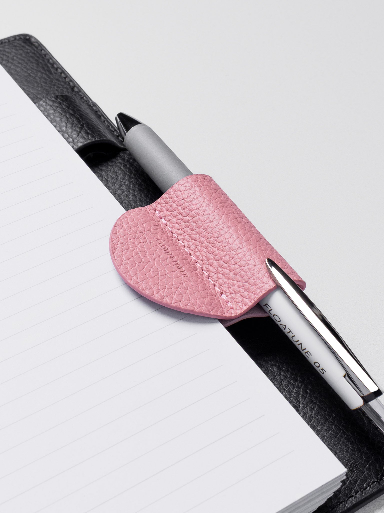 Magnetic Bookmark | Pen Holder in color Fig Milk (light pink) with pen in pen loop.