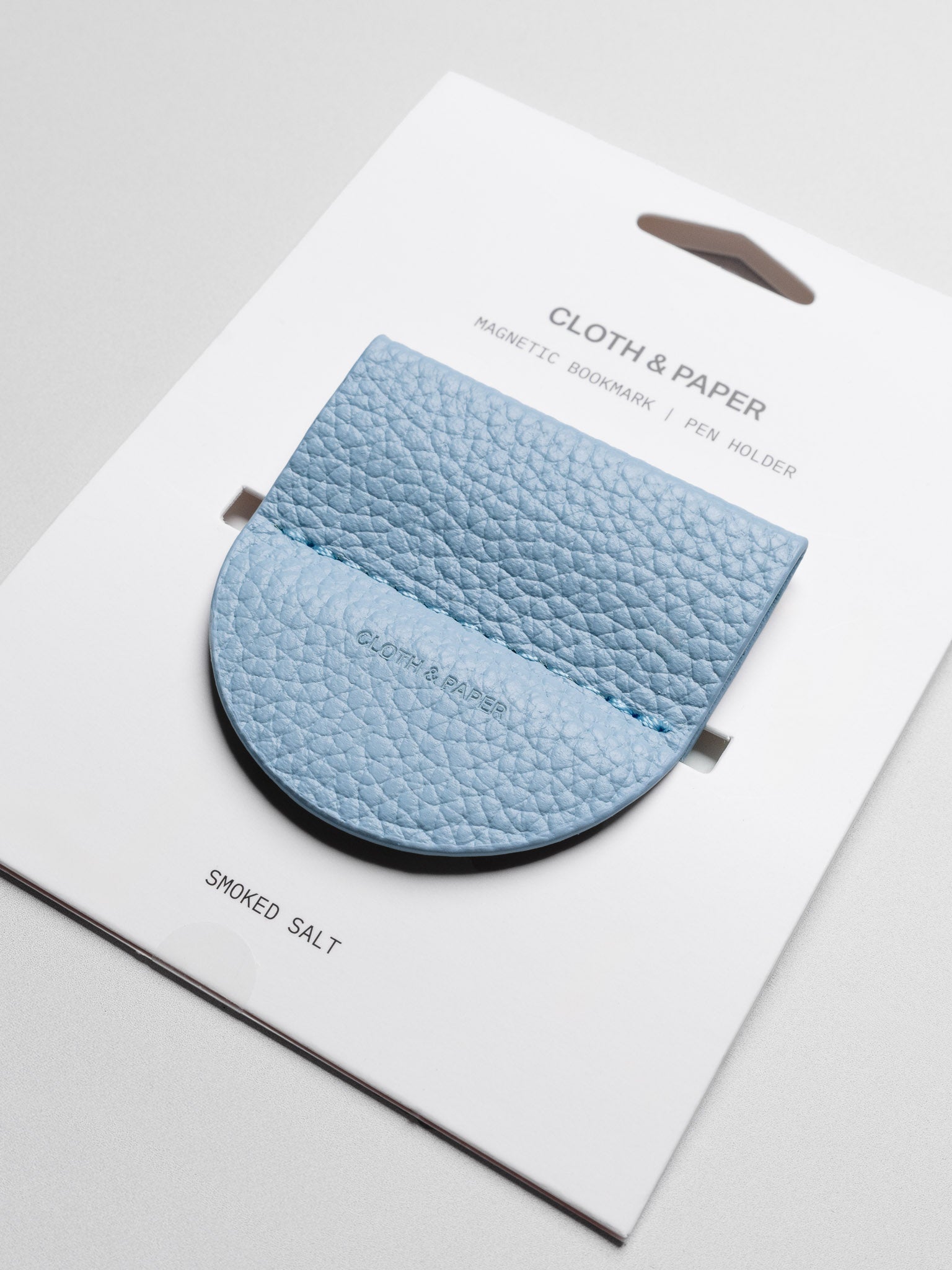Magnetic Bookmark | Pen Holder in color Smoked Salt (light blue) shown in packaging.