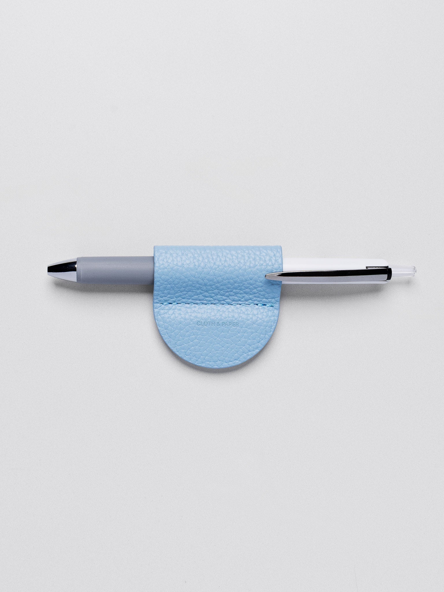 Magnetic Bookmark | Pen Holder in color Smoked Salt (light blue) with pen in pen loop.