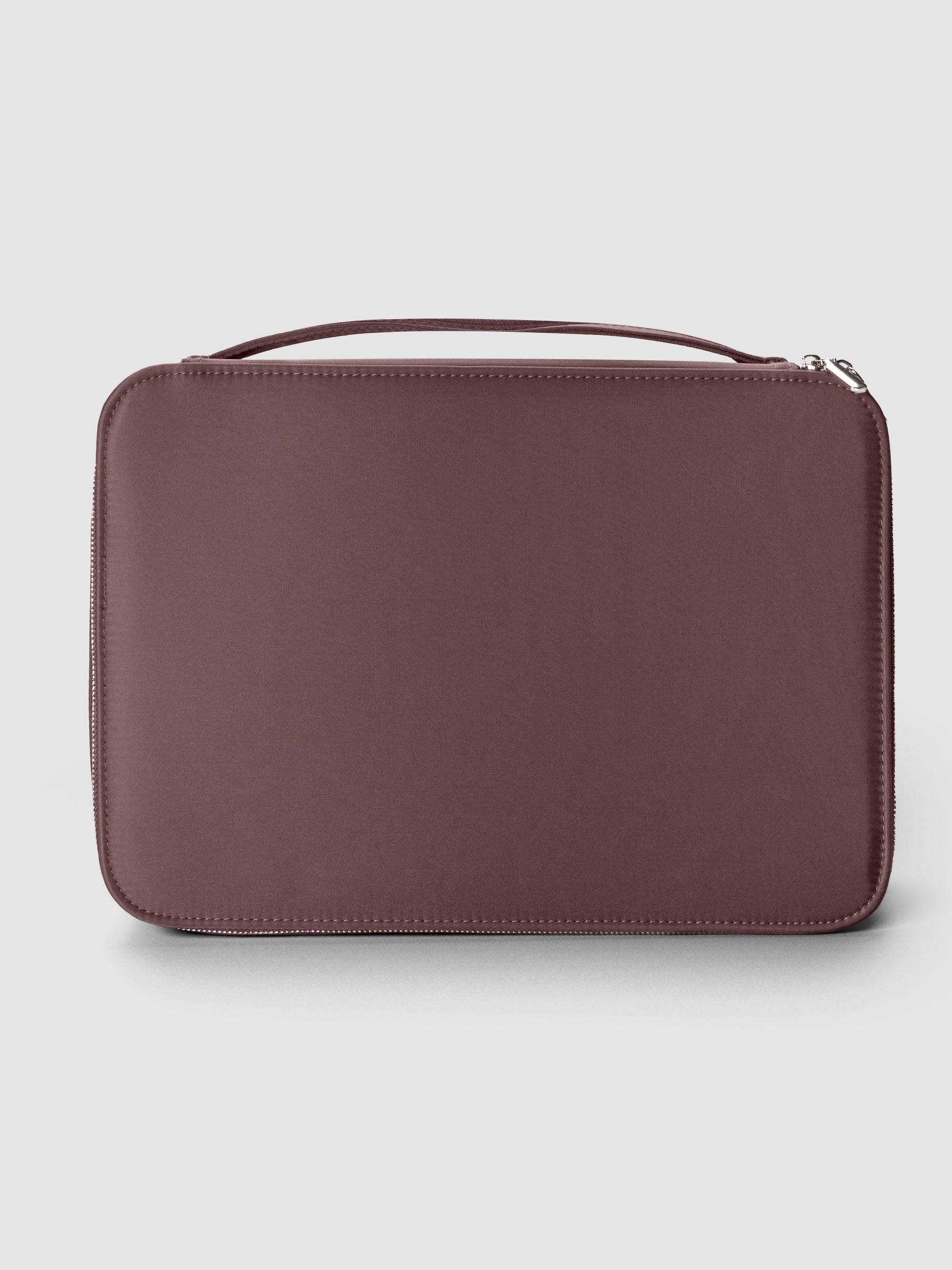 Large zippered packing cube in the color walnut against a neutral background.