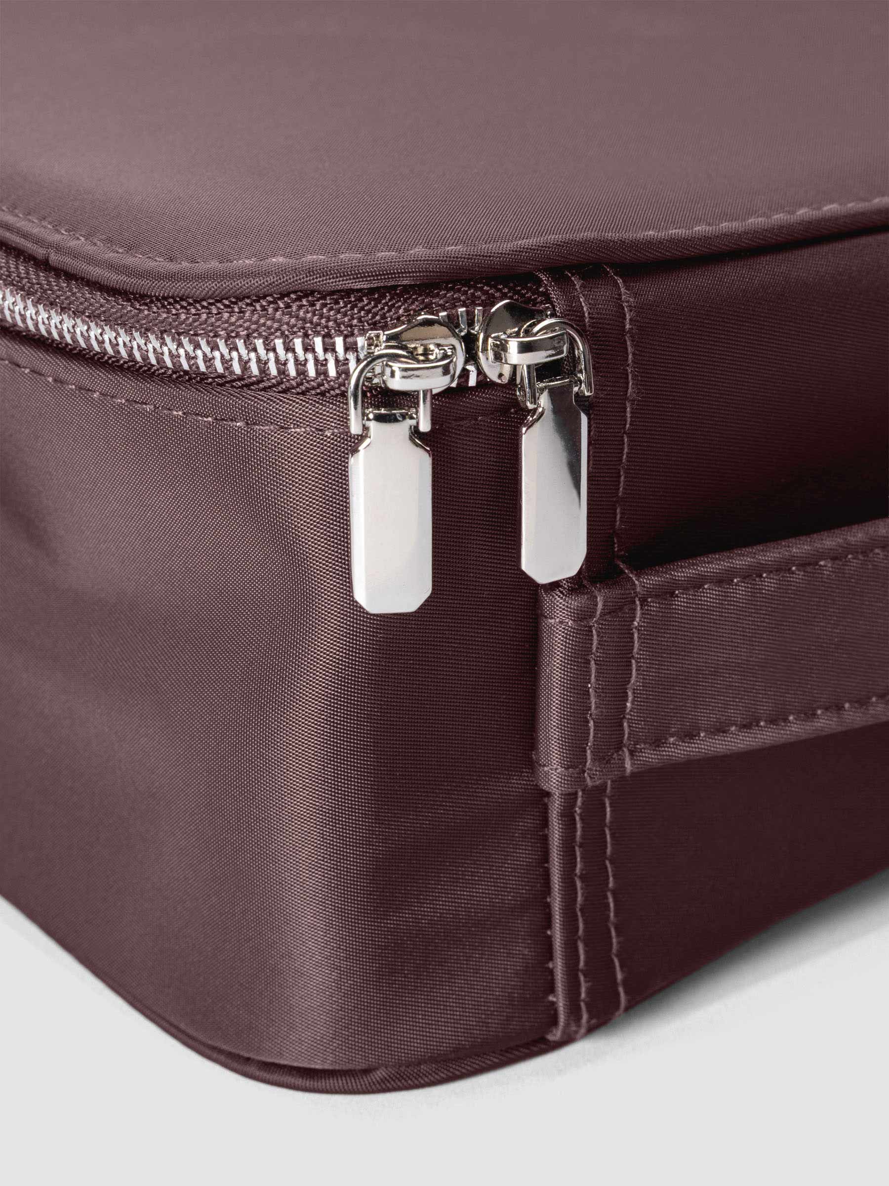 Close up images of the packing cubes silver zipper closures.