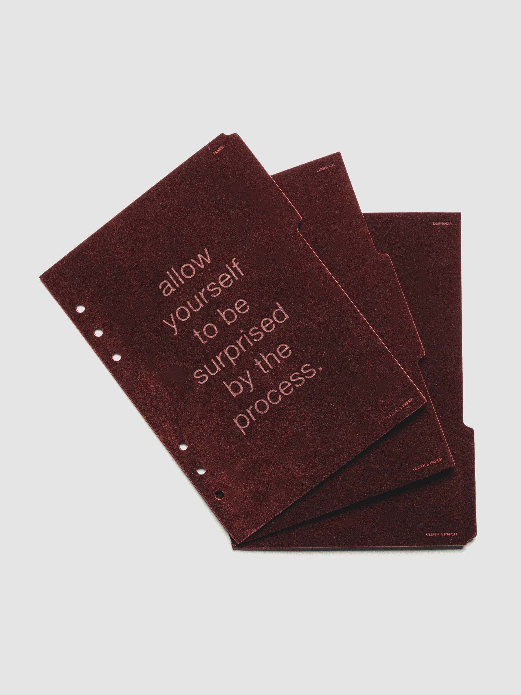 Three velvet side tab planners dividers in the color Bordeaux with text deboss designs shown offset in size A5.