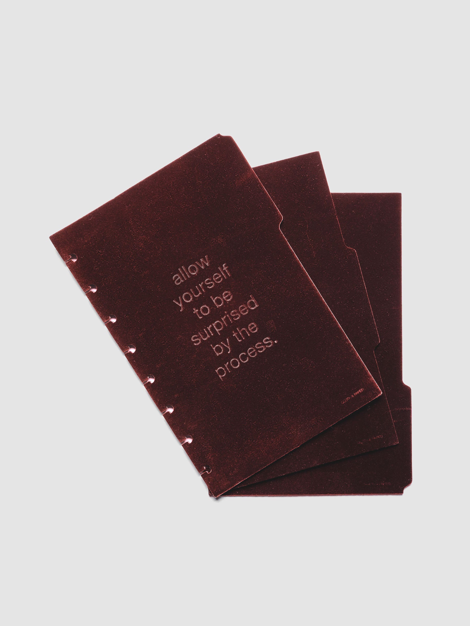 Three velvet side tab planners dividers in the color Bordeaux with text deboss designs shown offset in size Half Letter.
