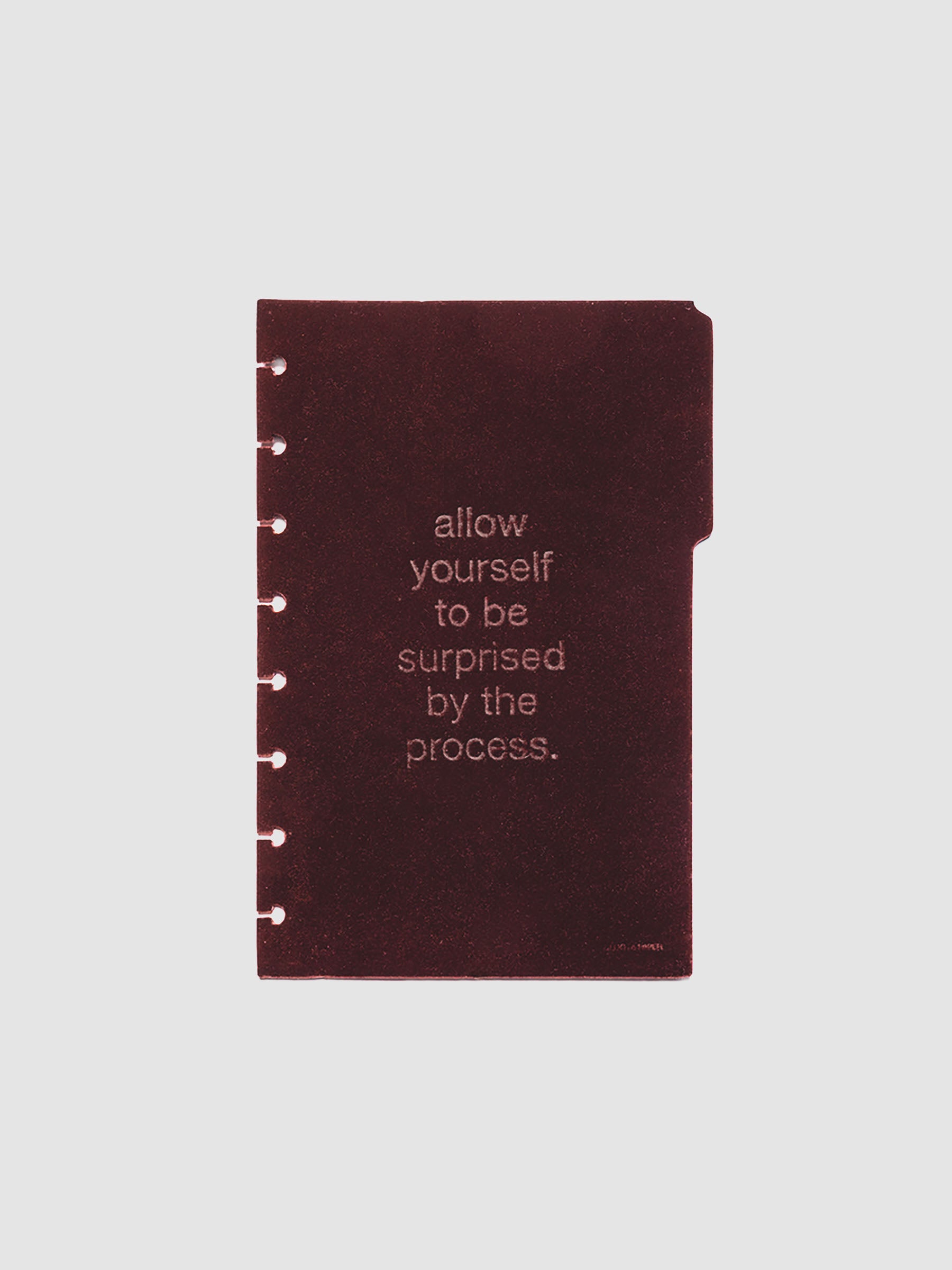 First velvet side tab planners dividers in the color Bordeaux with text deboss design reading "allow yourself to be surprised by the process" in size Half Letter.