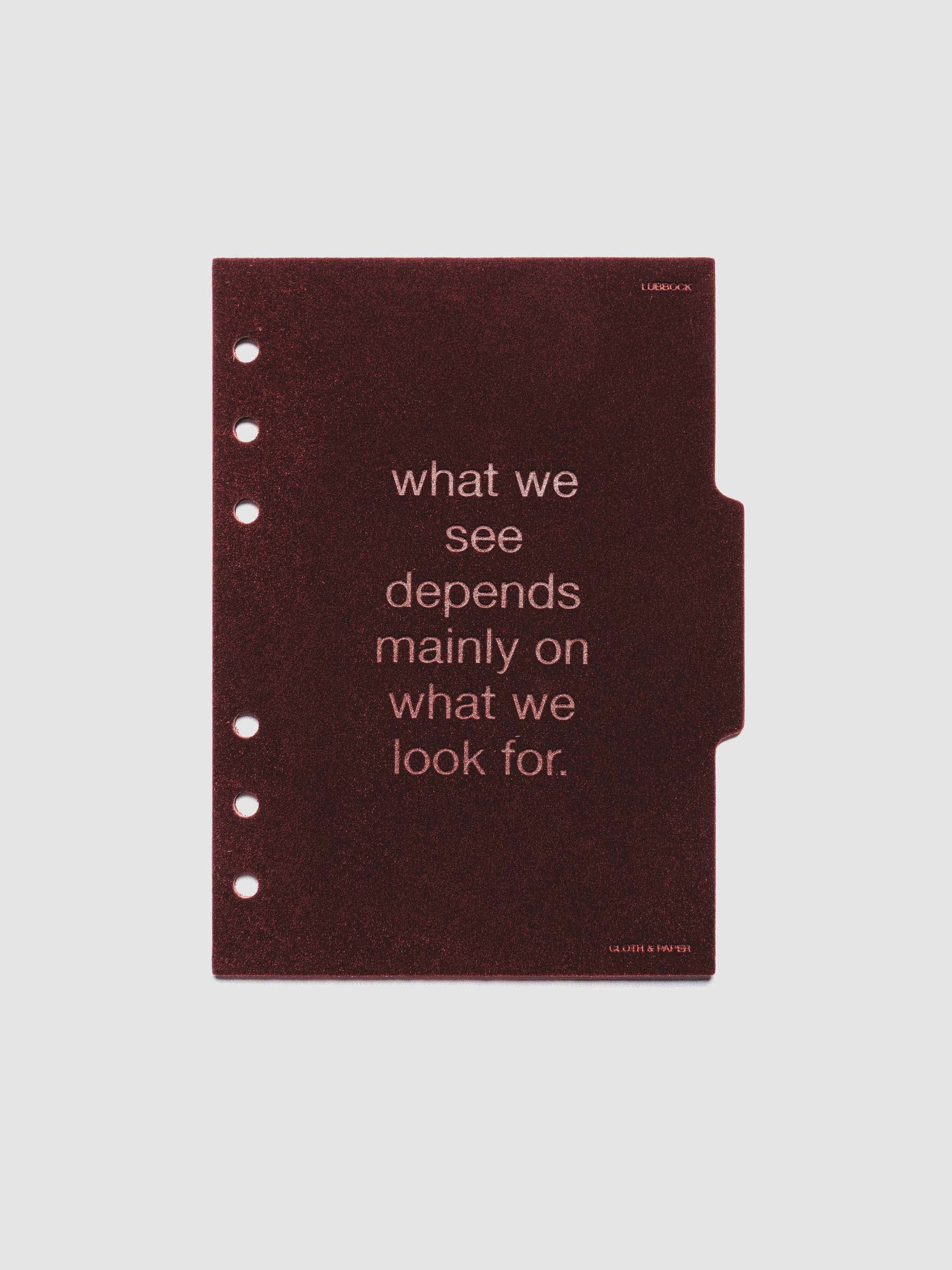 Second velvet side tab planners dividers in the color Bordeaux with text deboss design reading "what we see depends mainly on what we look for" in size Personal Wide.