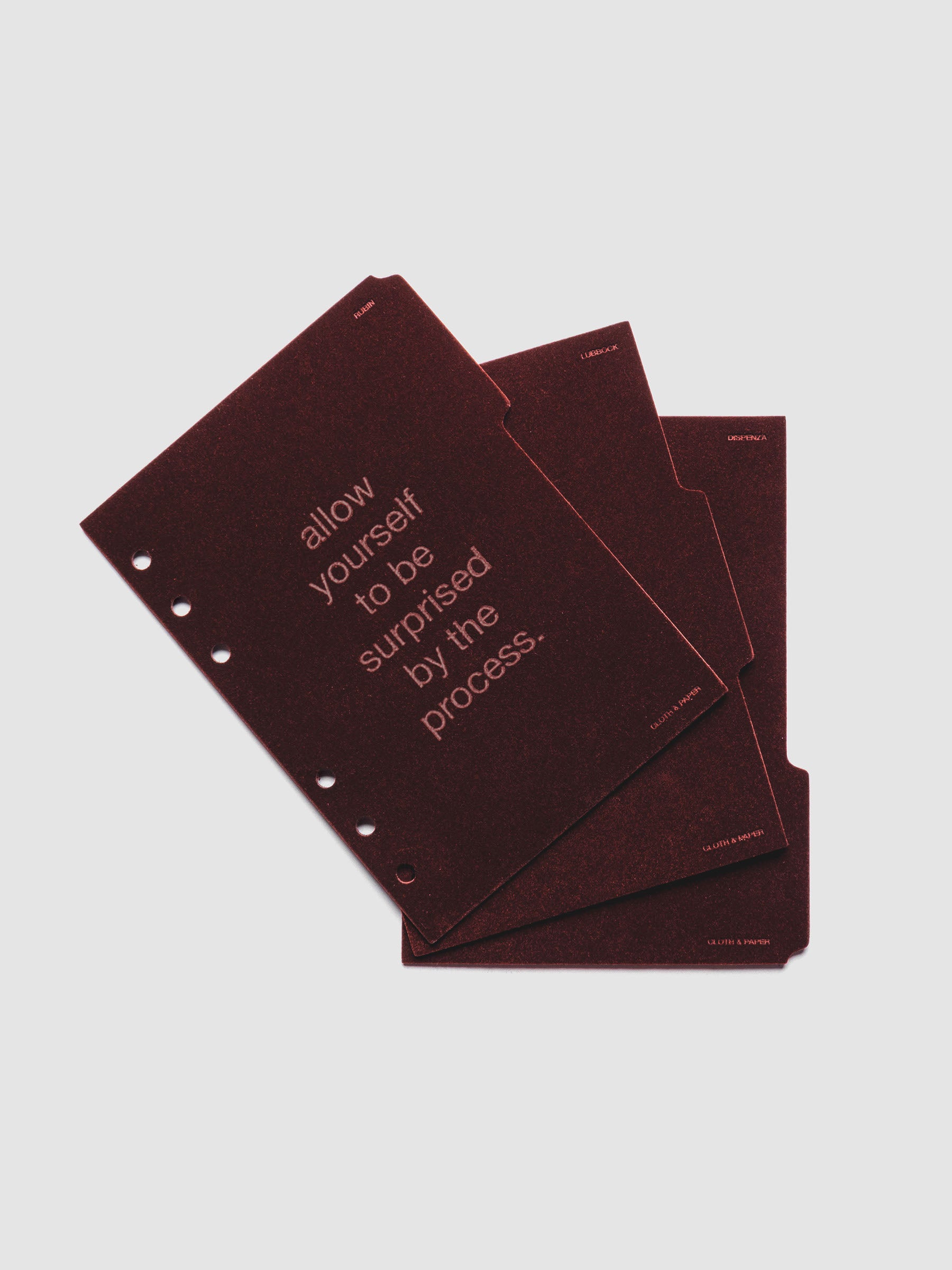 Three velvet side tab planners dividers in the color Bordeaux with text deboss designs shown offset in size Personal Wide.