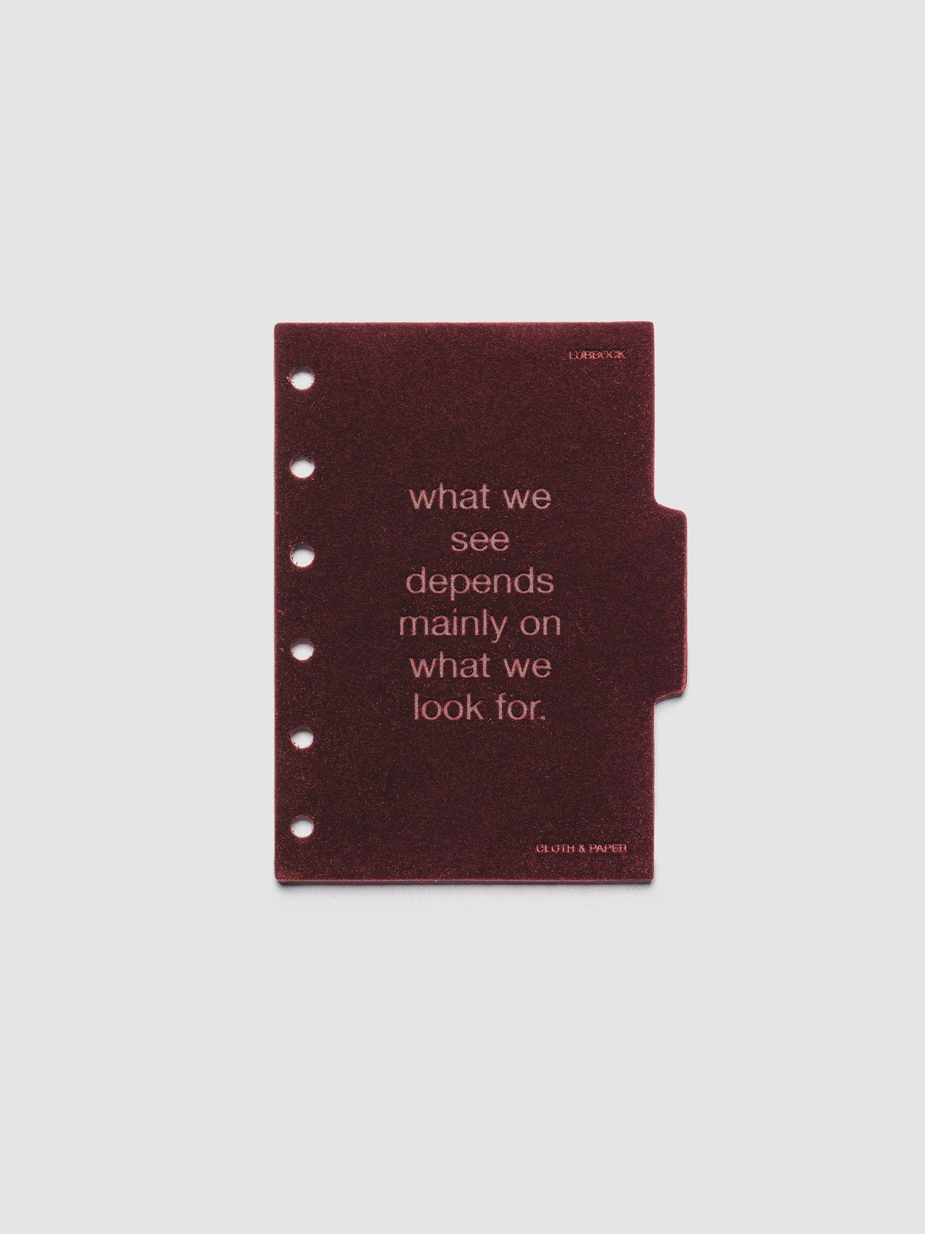 Second velvet side tab planners dividers in the color Bordeaux with text deboss design reading "what we see depends mainly on what we look for" in size Pocket.