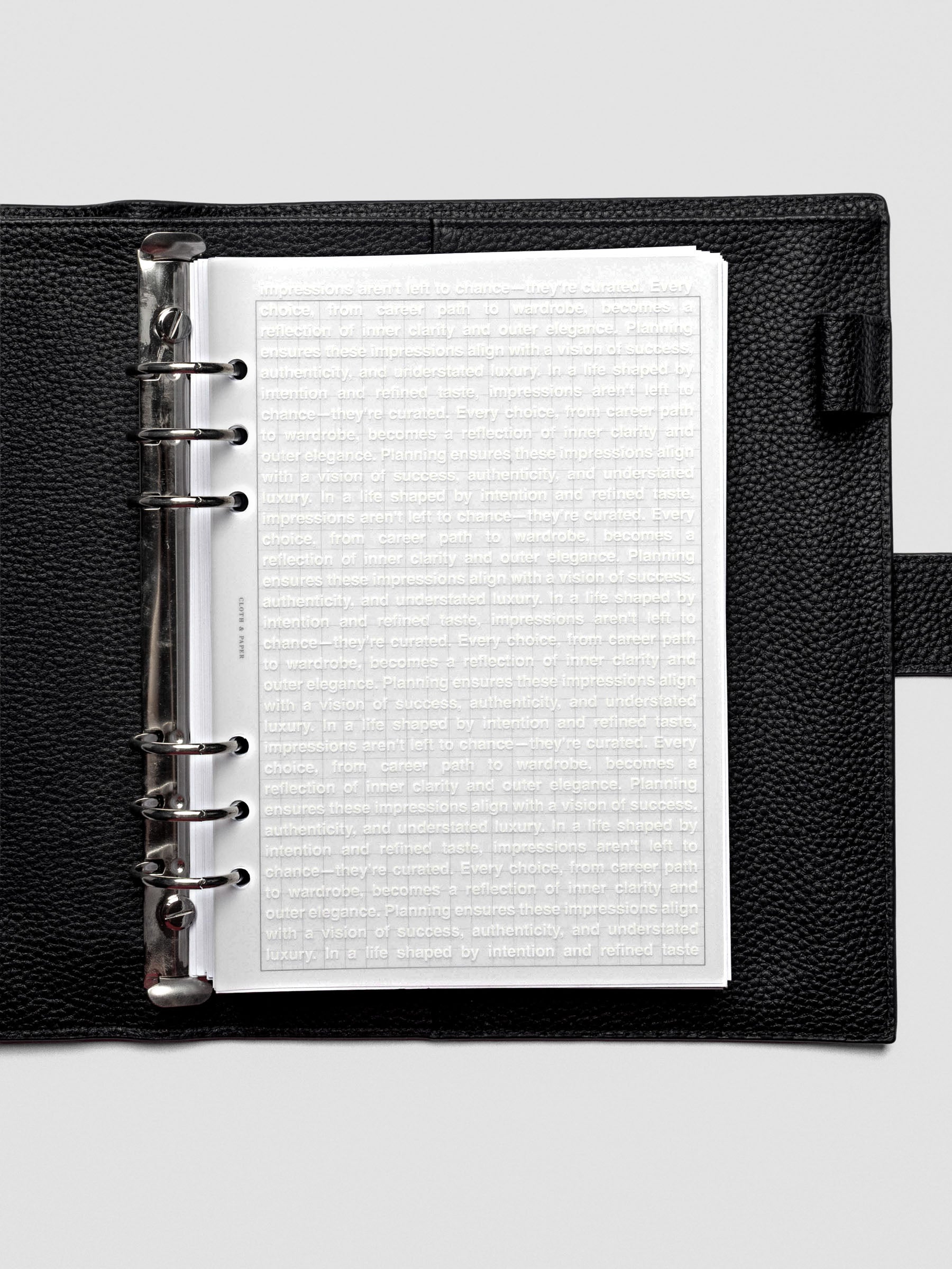 A5 Impressions Dashboard shown inside a ring-bound planner with translucent layering.