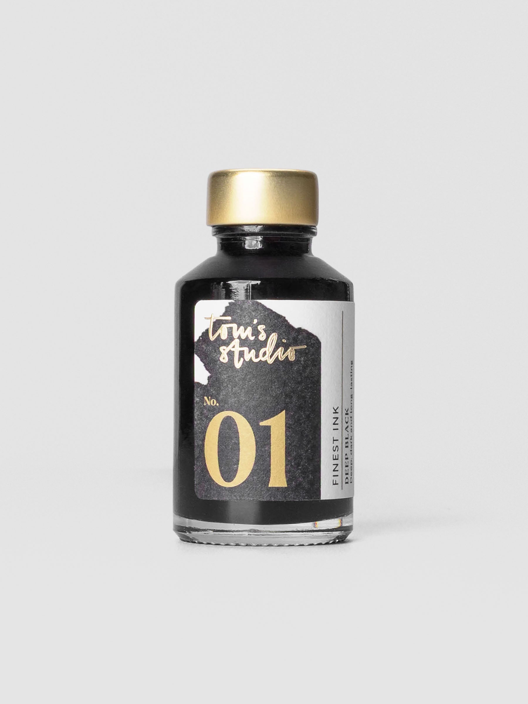 Bottle of Tom’s Studio Fountain Pen Ink in Deep Black with minimal label design.