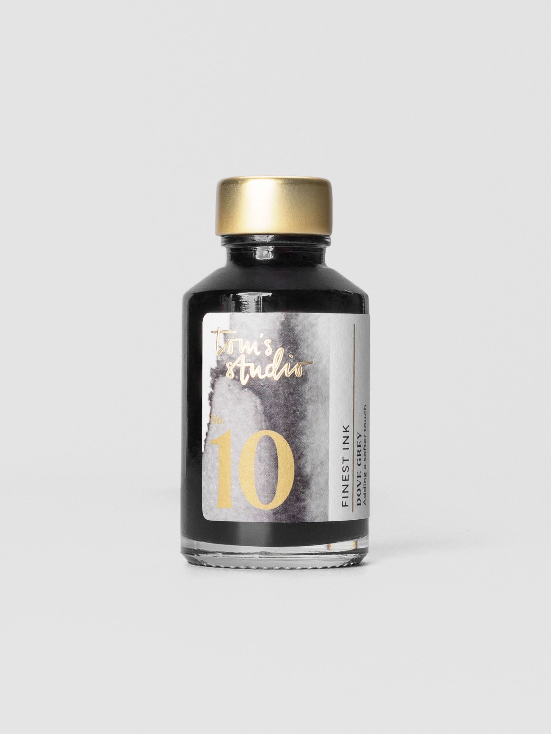 Bottle of Tom’s Studio Fountain Pen Ink in Dove Grey with refined minimalist label.