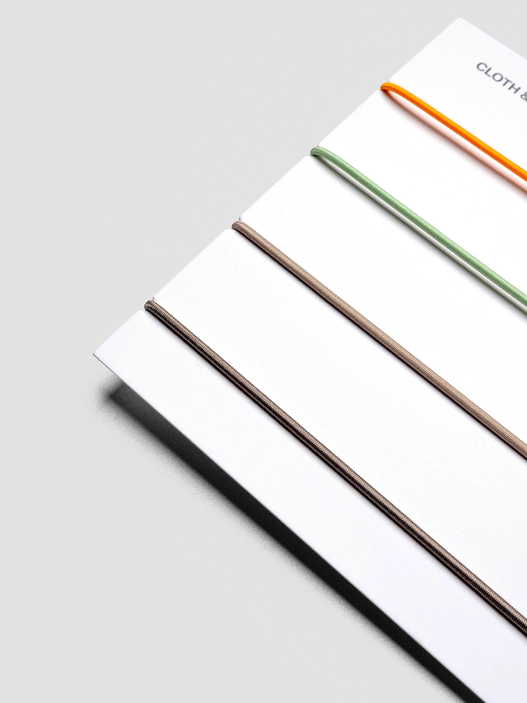 Angled packaging view with four elastic cover bands.