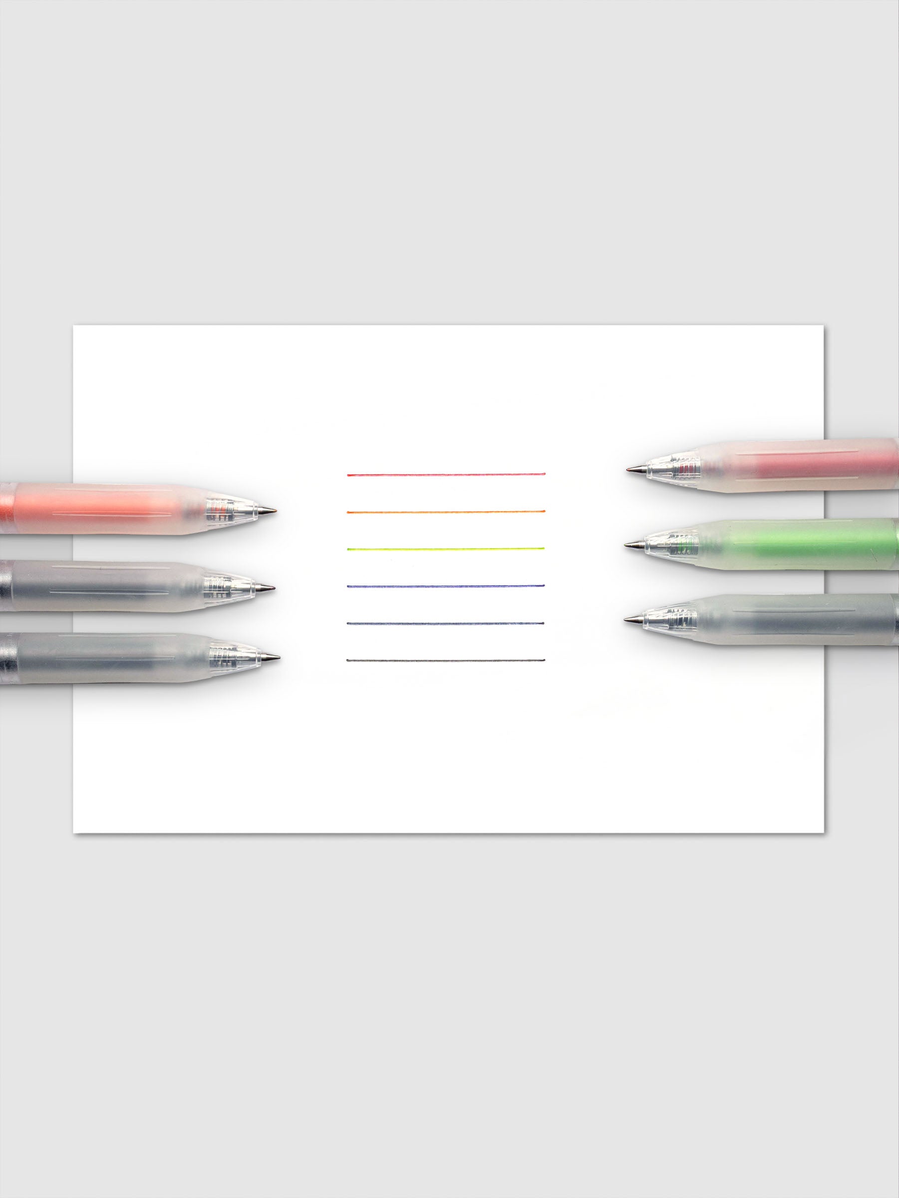 Set of six Zebra Sarasa Chill gel pens with clear barrels in red, green, orange, black, blue, and dark blue arranged together.