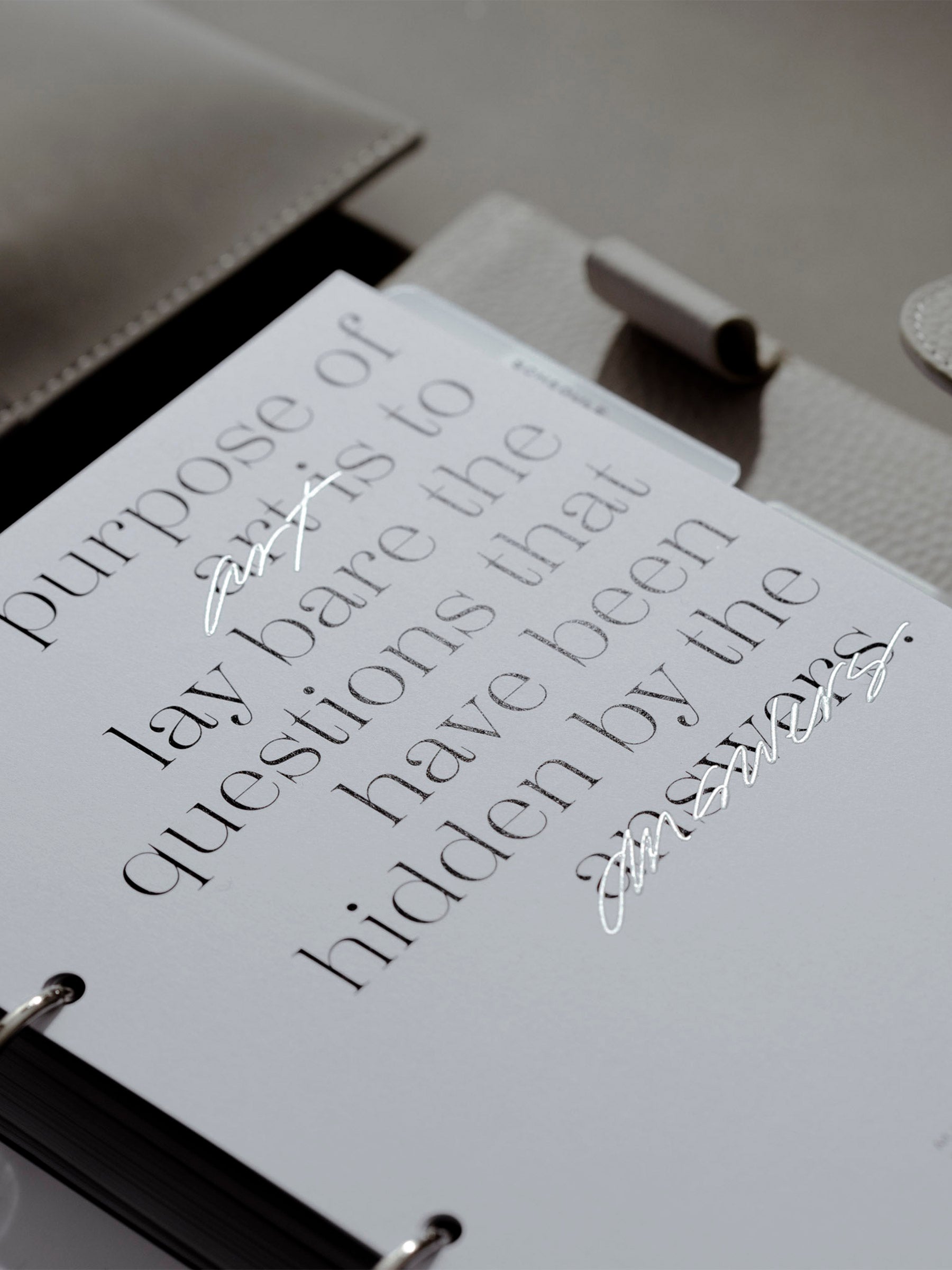 Dashboard in use inside a leather planner. The lighting highlights the spot gloss so it appears shiny.